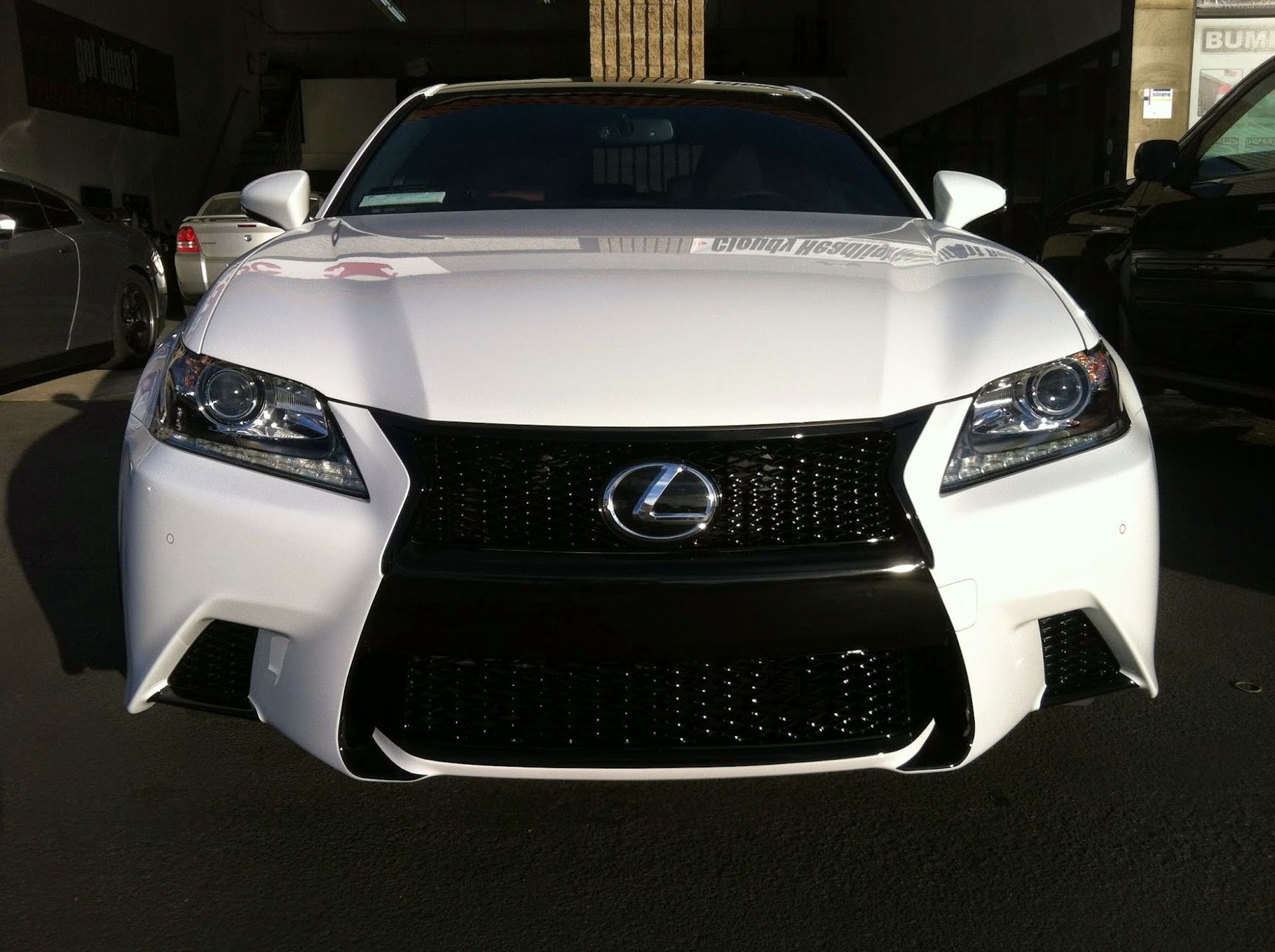 White Lexus GS sedan with black grille, parked outside.