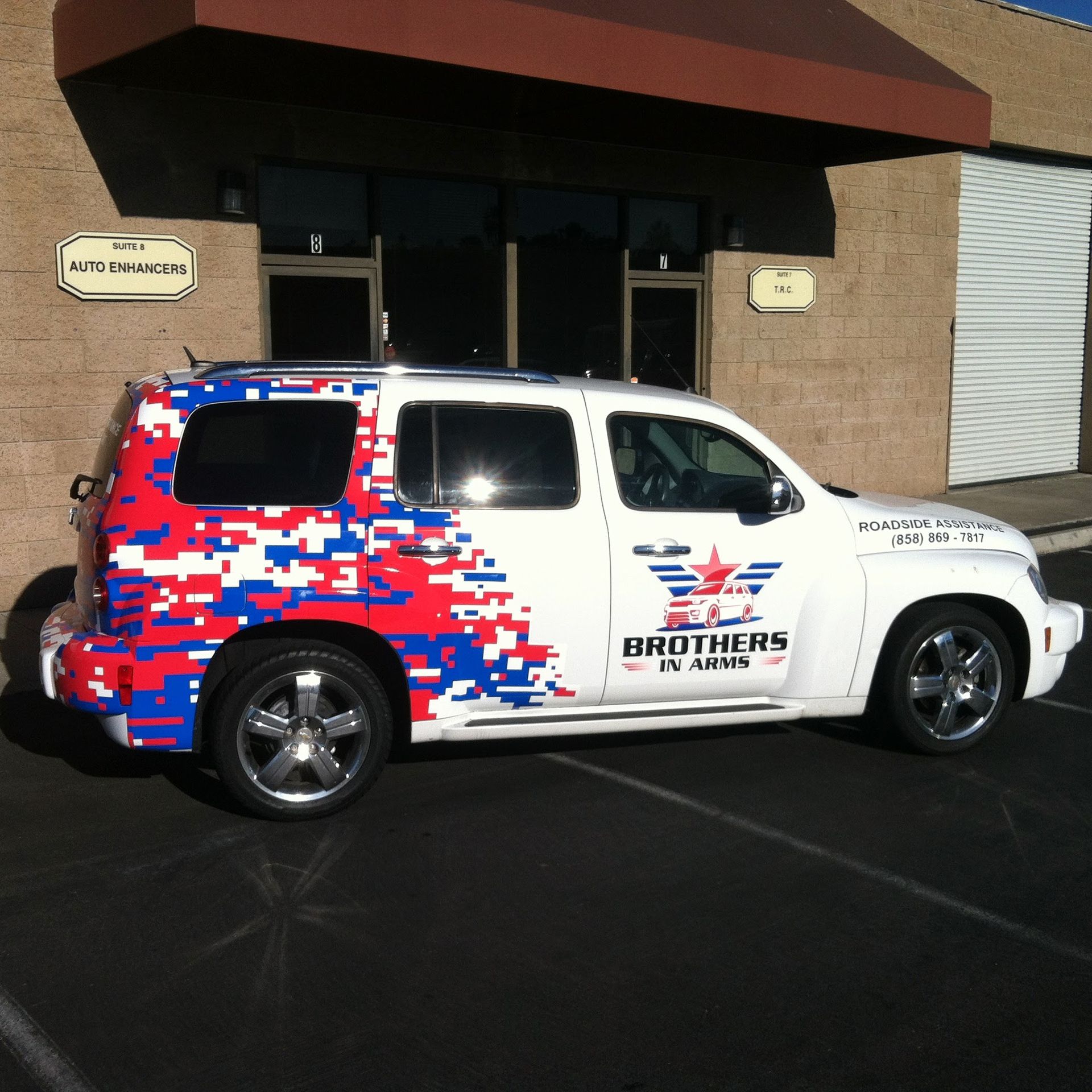 White SUV with red, white, and blue digital camo. 
