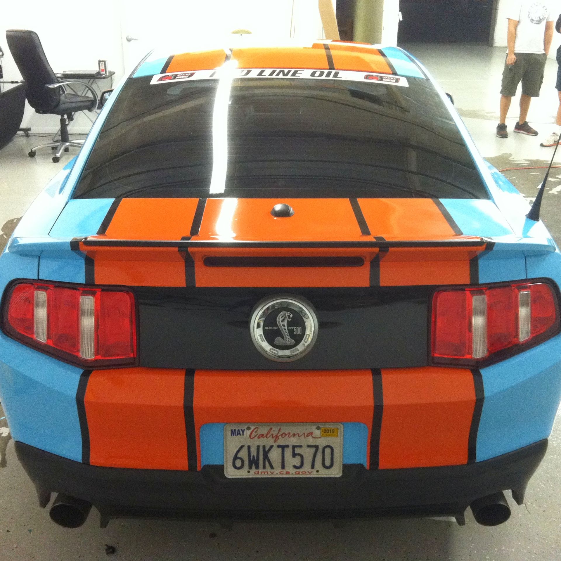 Blue and orange Ford Mustang with black outline, California license plate.