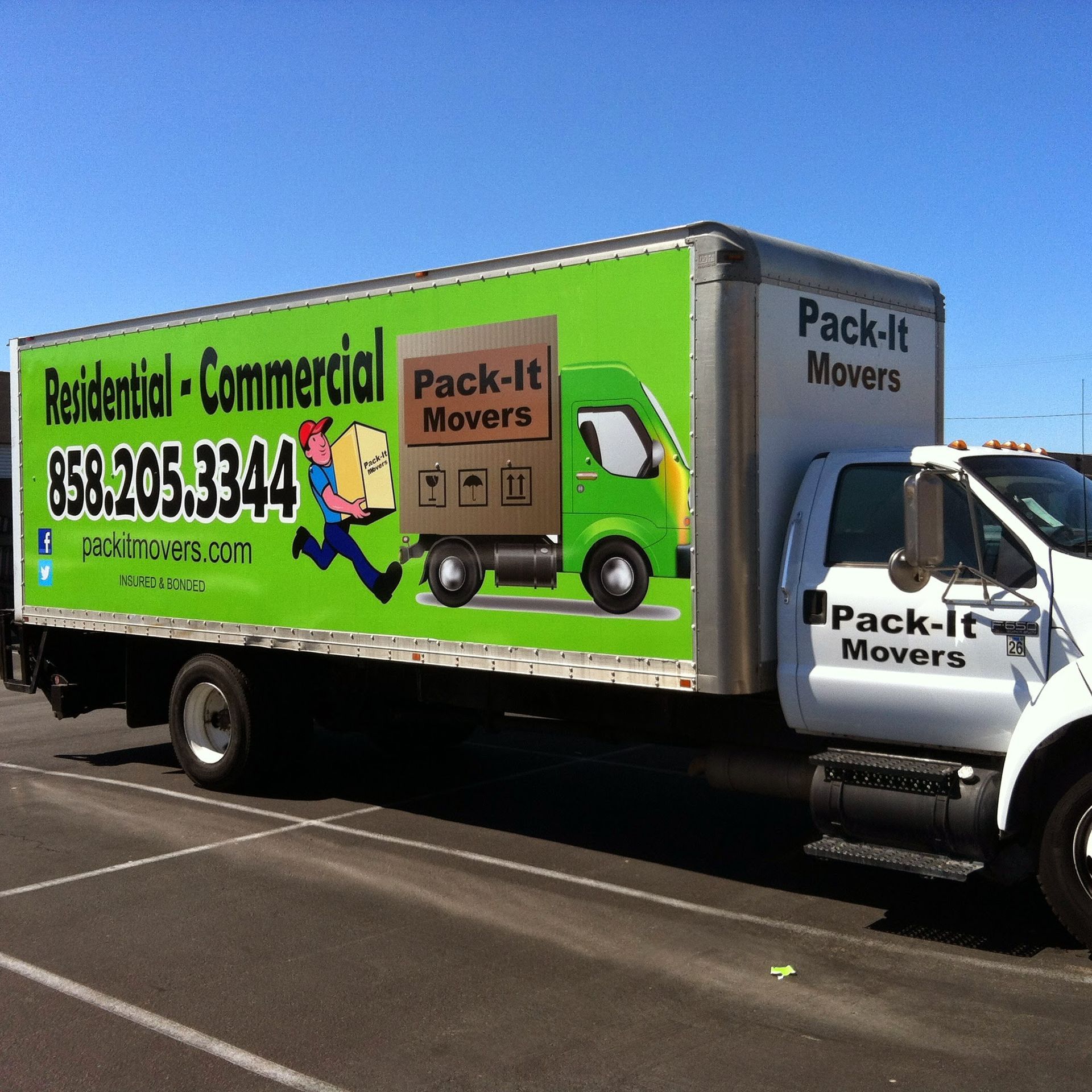Moving truck with green and white branding; advertisement for 