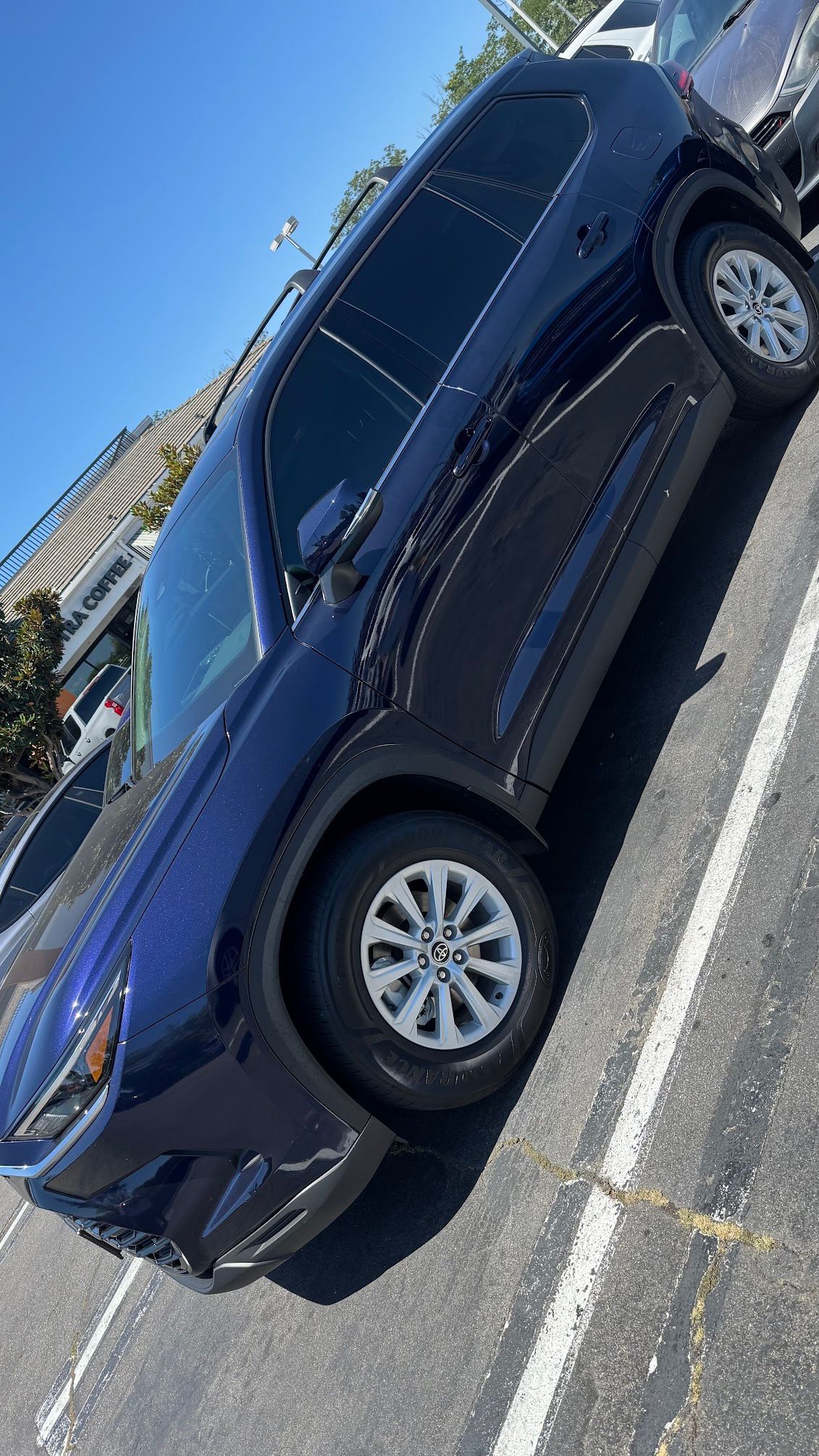 Blue SUV parked outdoors on a sunny day.