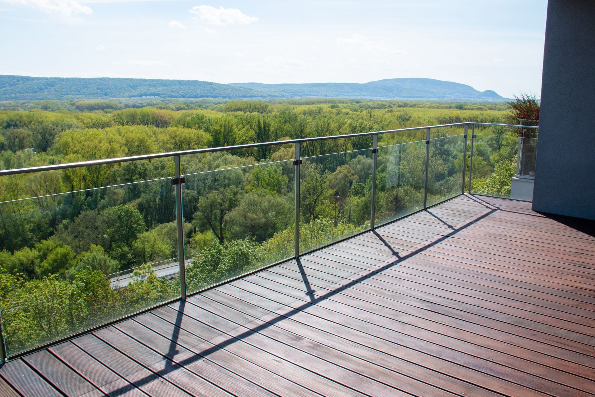 A balcony with a view of a forest and mountains