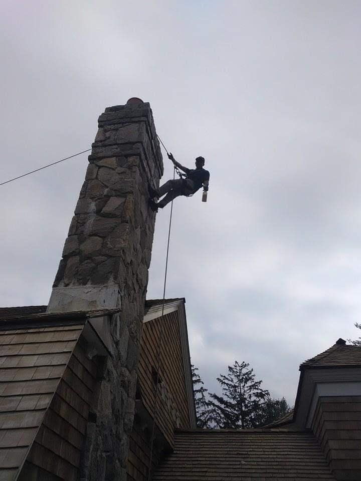 Workers on top of house for roof repair