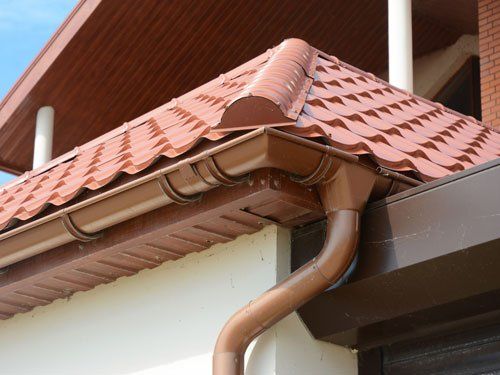 Close up on roof gutter and downspout pipe