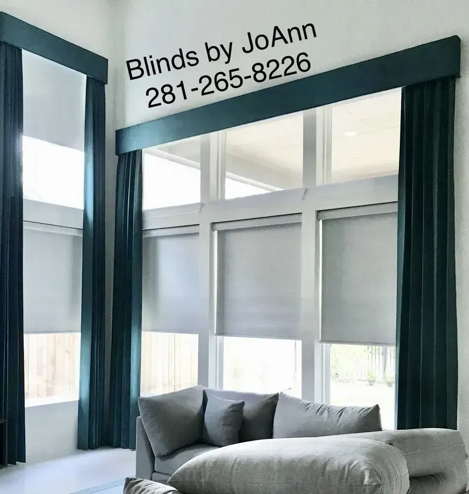 Living room with teal curtains, valance, and gray roller shades; sofa.