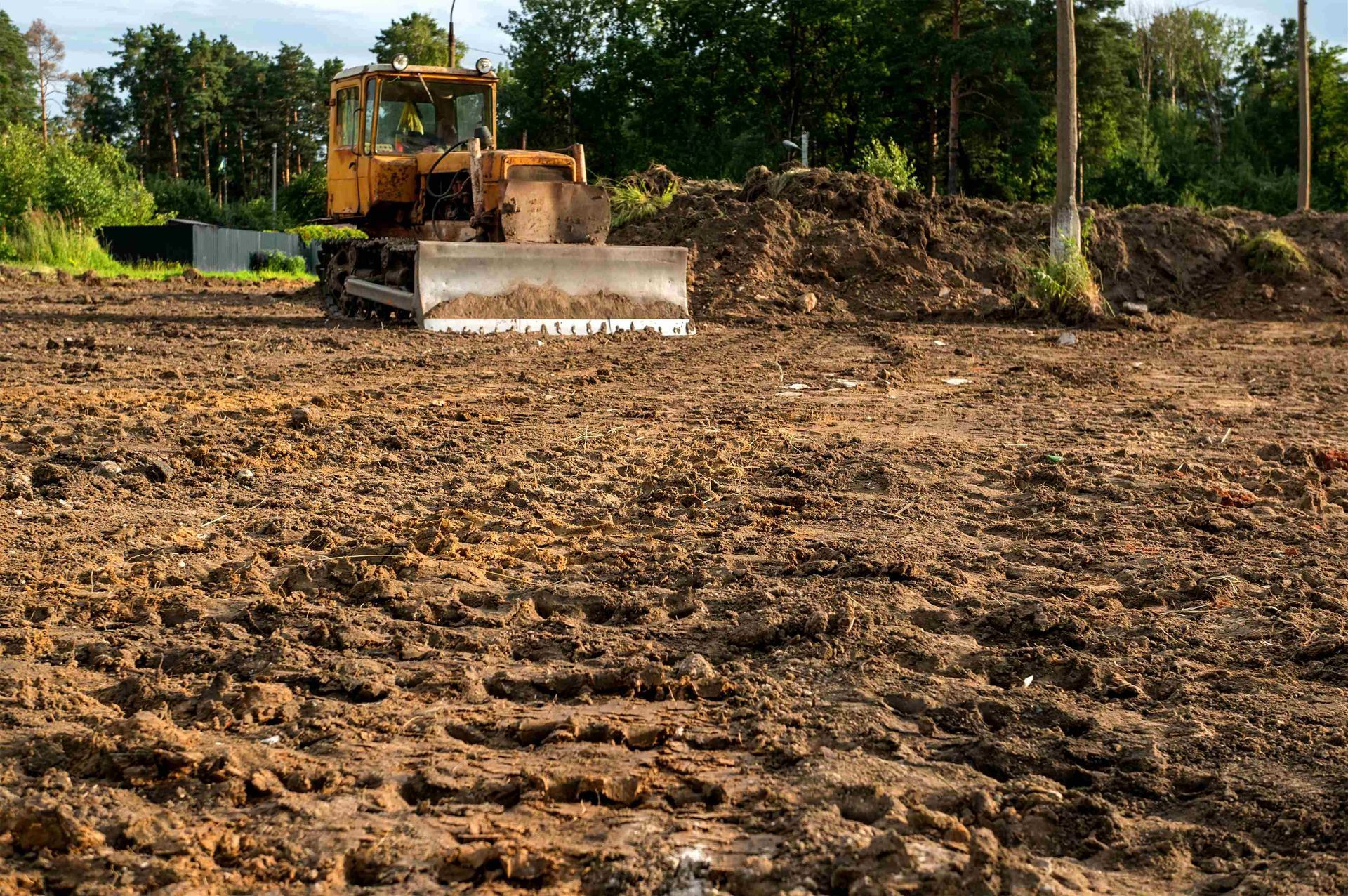 a bulldozer is working on a dirt field