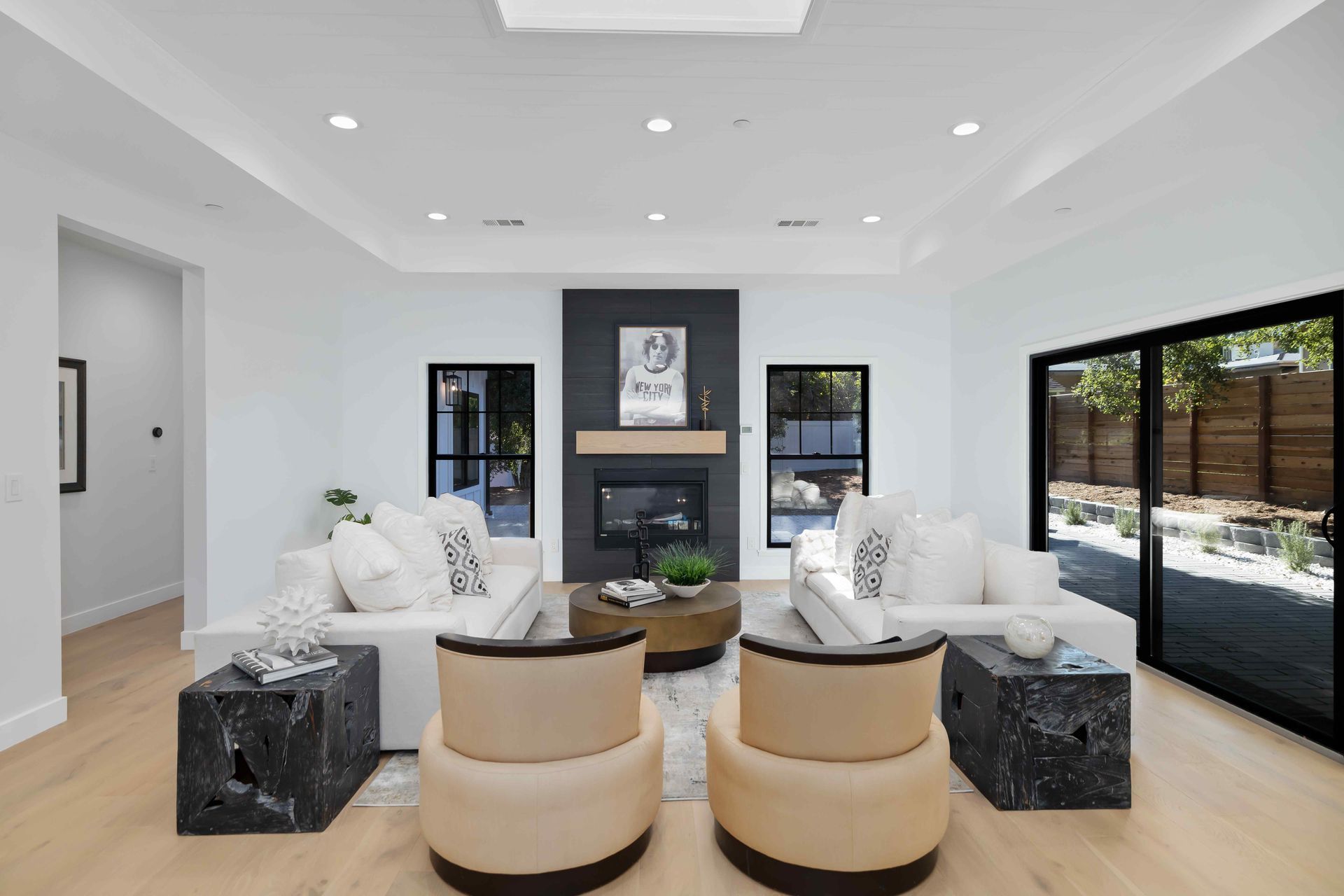 Modern living room with white walls, fireplace, and beige furniture.