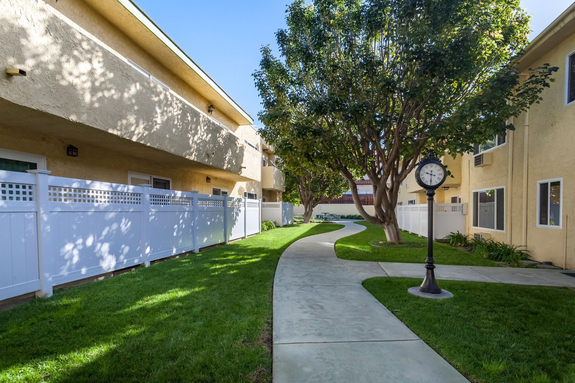 A clock on a pole in front of a building