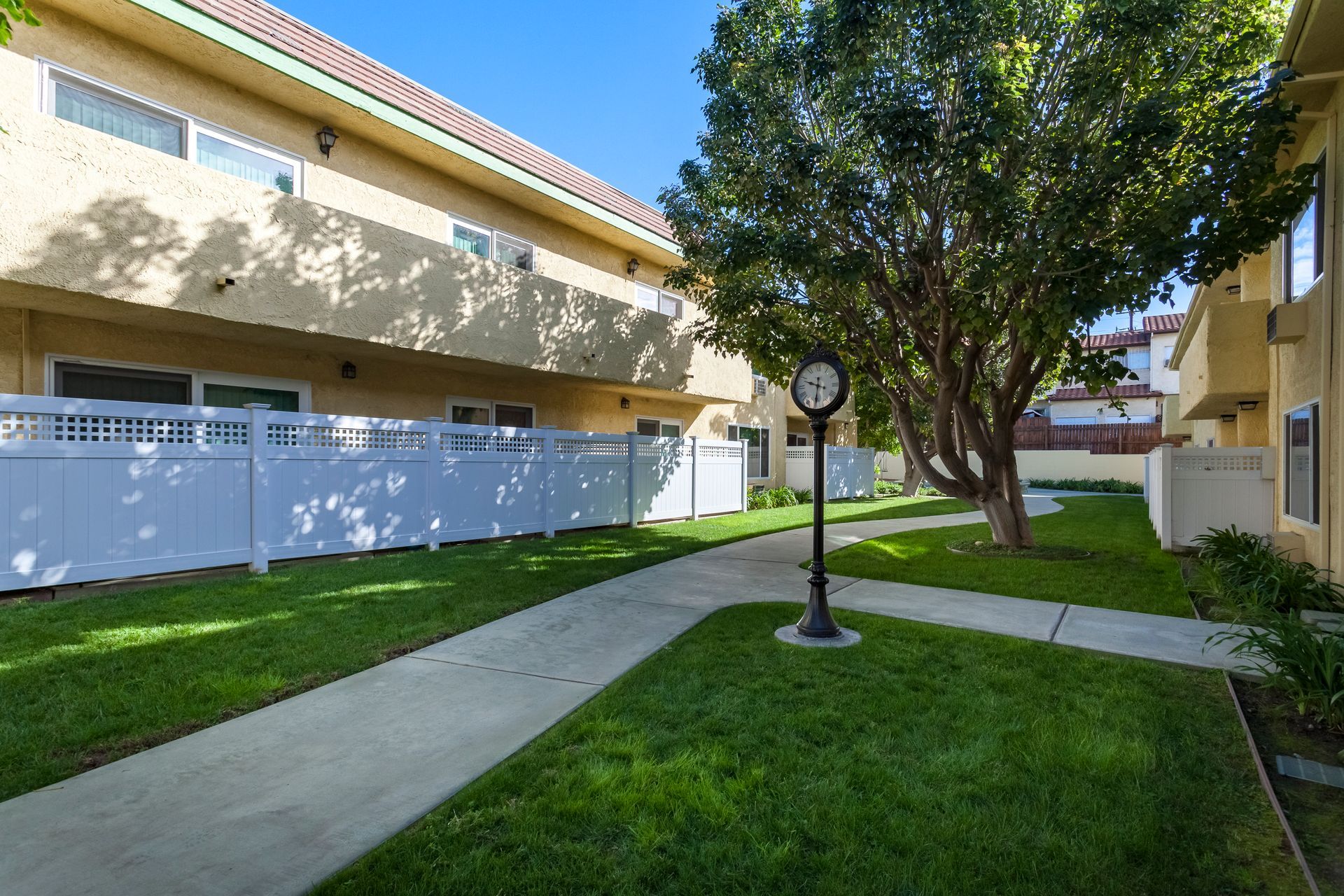 A clock on a pole in front of a building