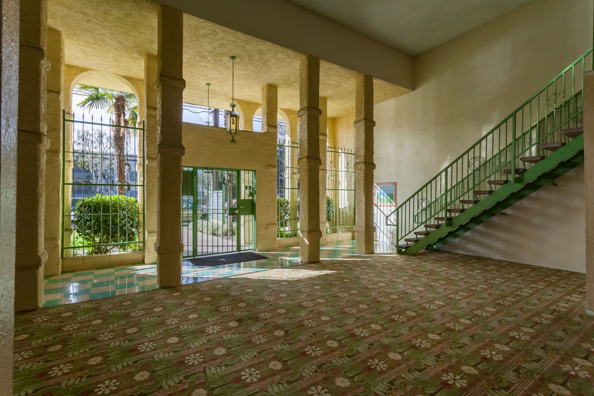 An empty lobby with stairs leading up to the second floor