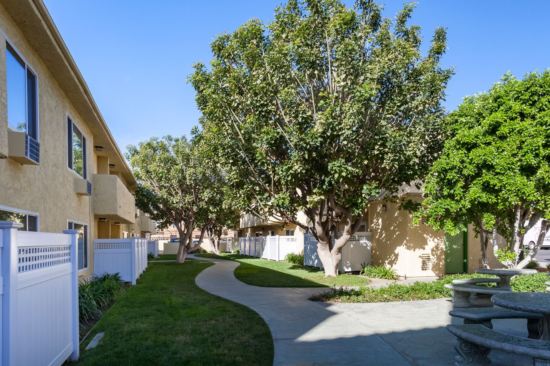 A row of apartment buildings with a picnic table in the middle