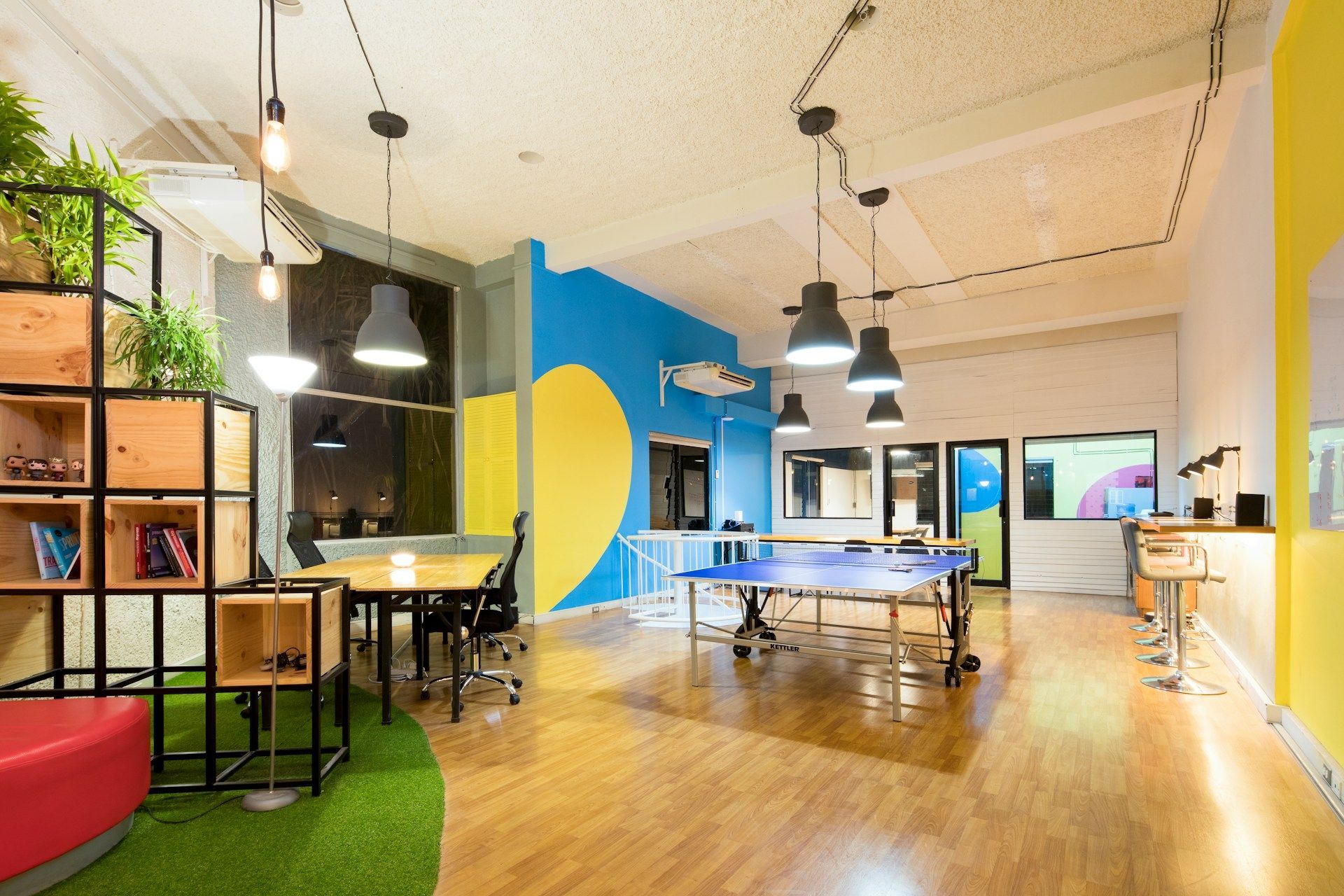 There is a ping pong table in the middle of the room.