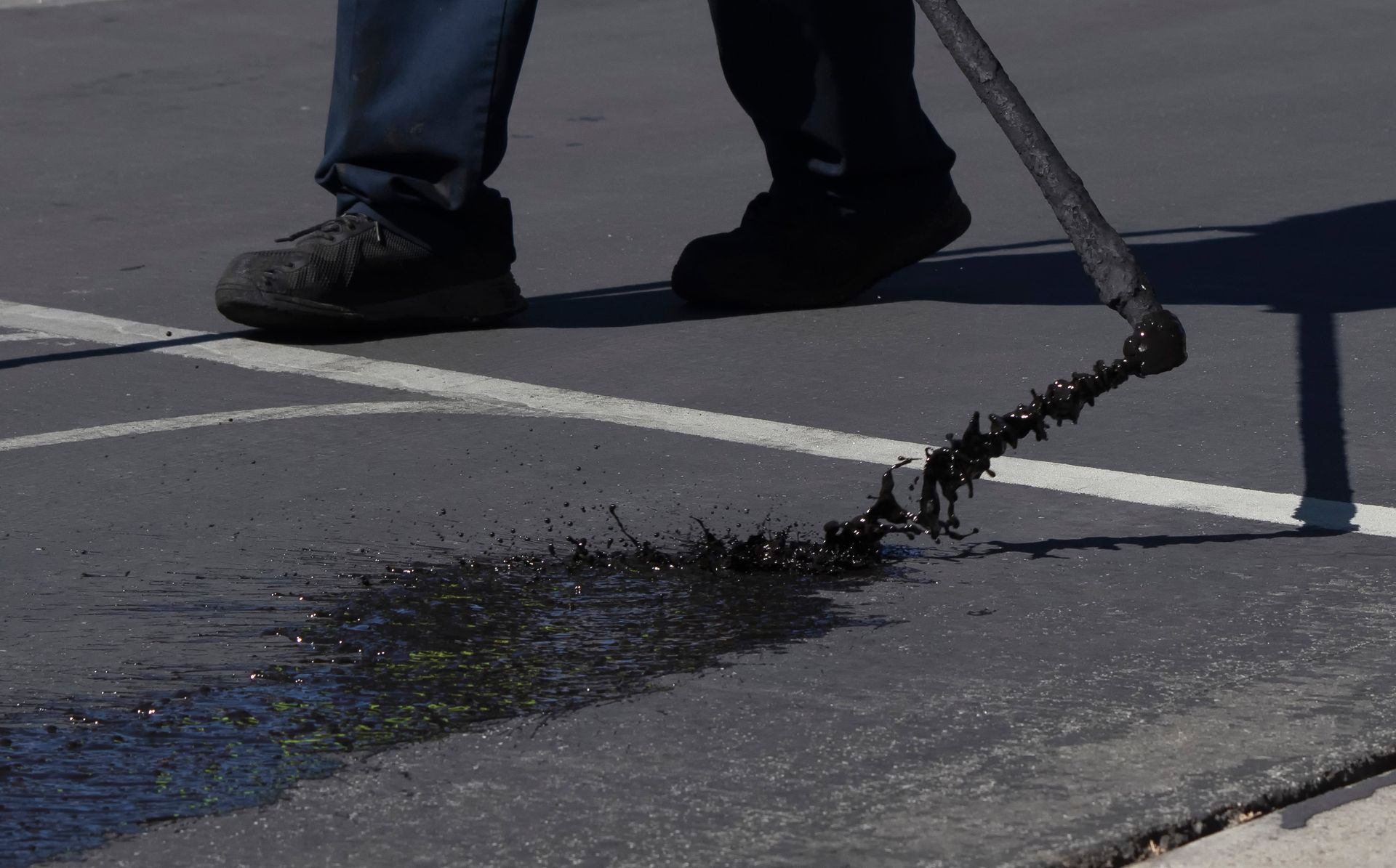 Seal Coating Brush During Asphalt Resurfacing — Bear, DE — Smith Paving & Contracting, Inc.