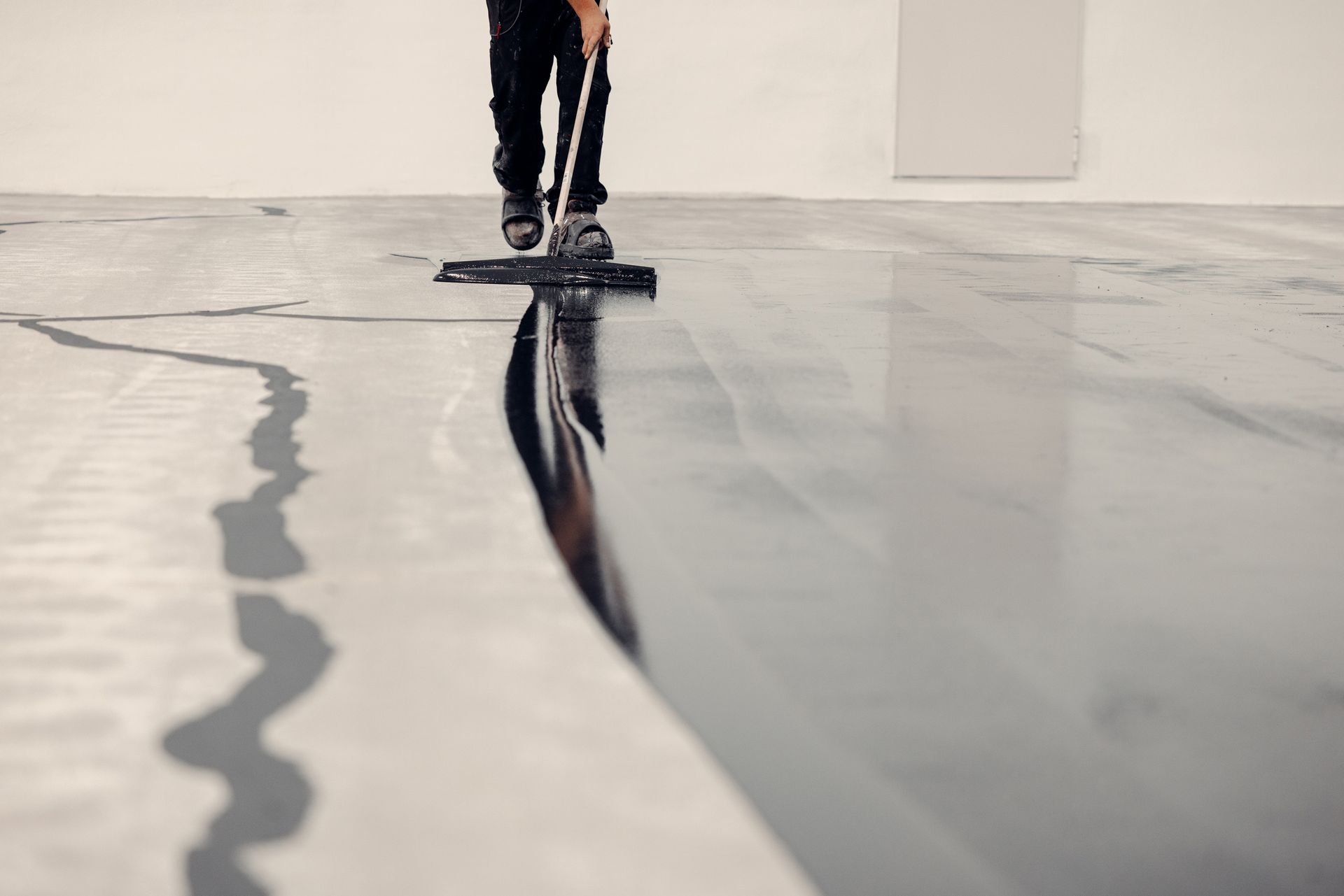 Worker Applies Grey Epoxy — Bear, DE — Smith Paving & Contracting, Inc.