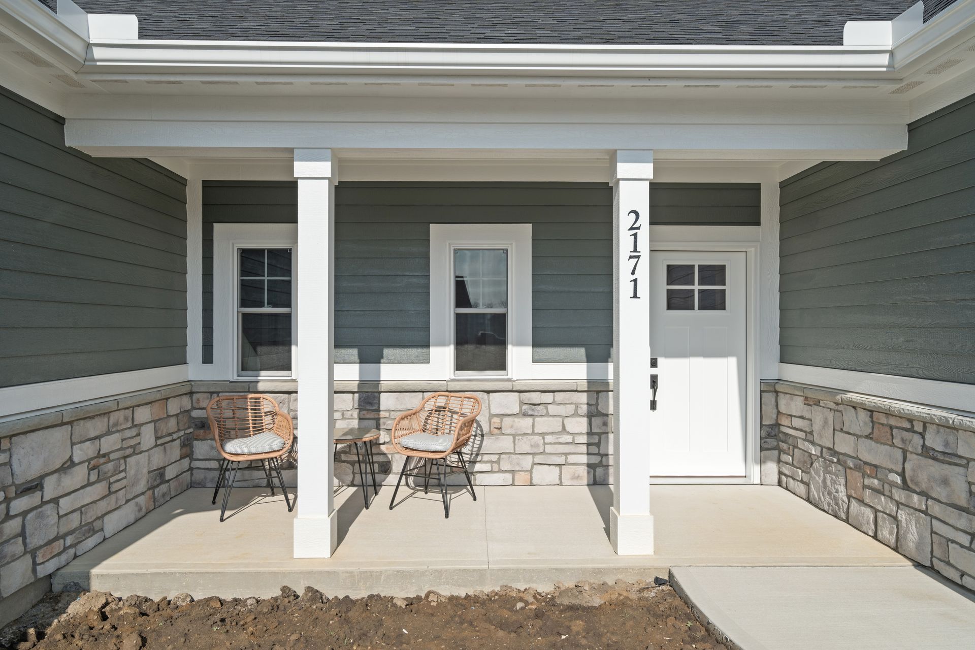The front porch of a house with the number 2411 on the door