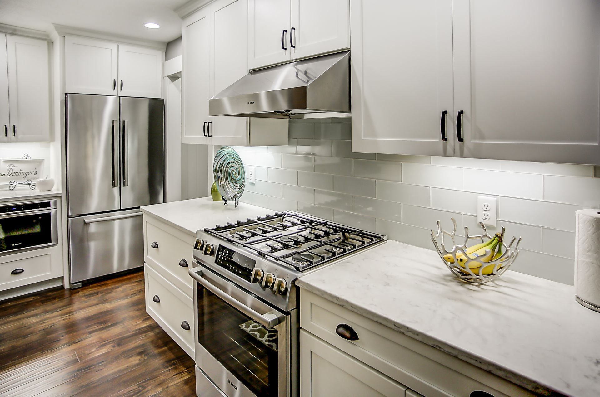 A kitchen with white cabinets and stainless steel appliances.