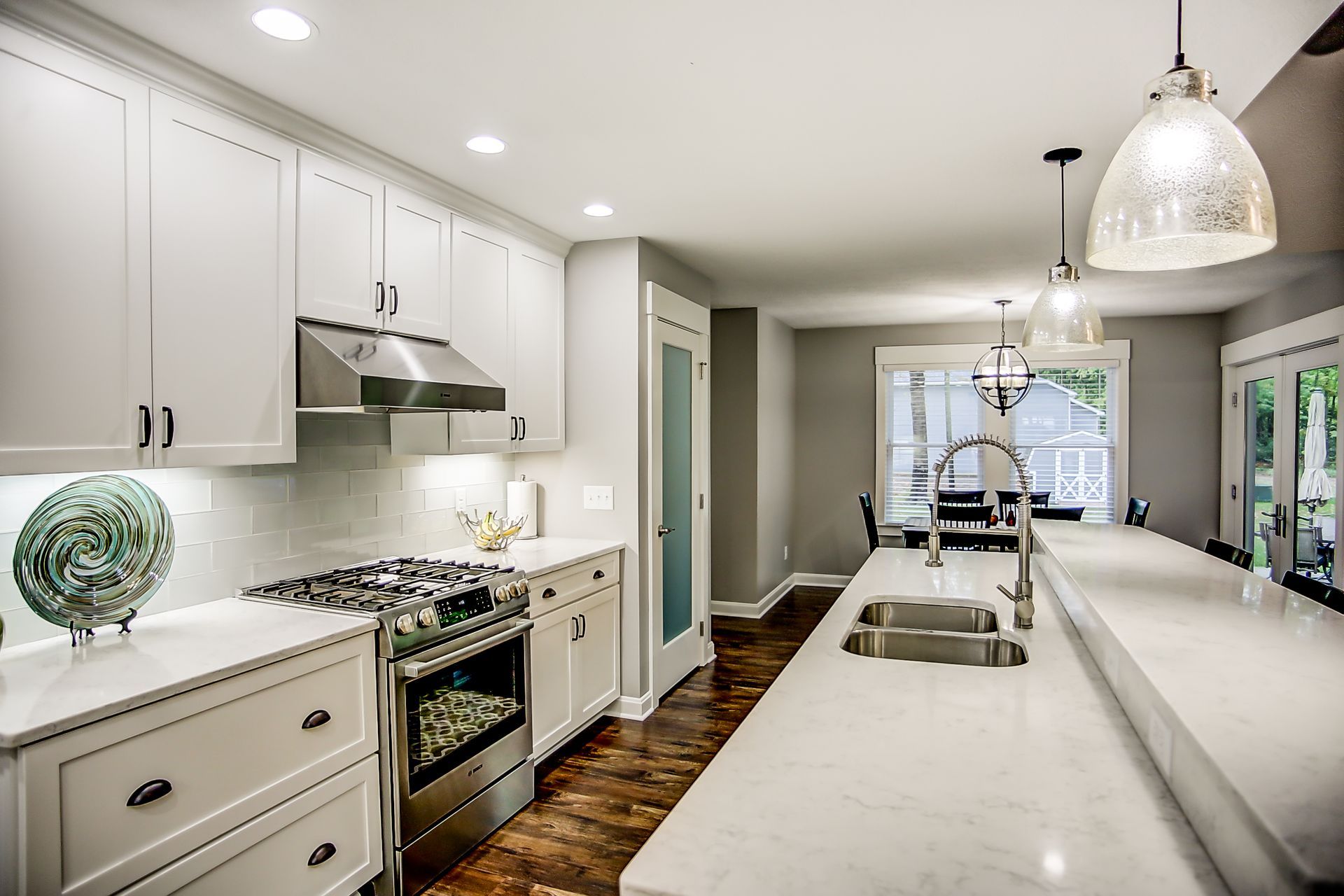 A kitchen with white cabinets and stainless steel appliances