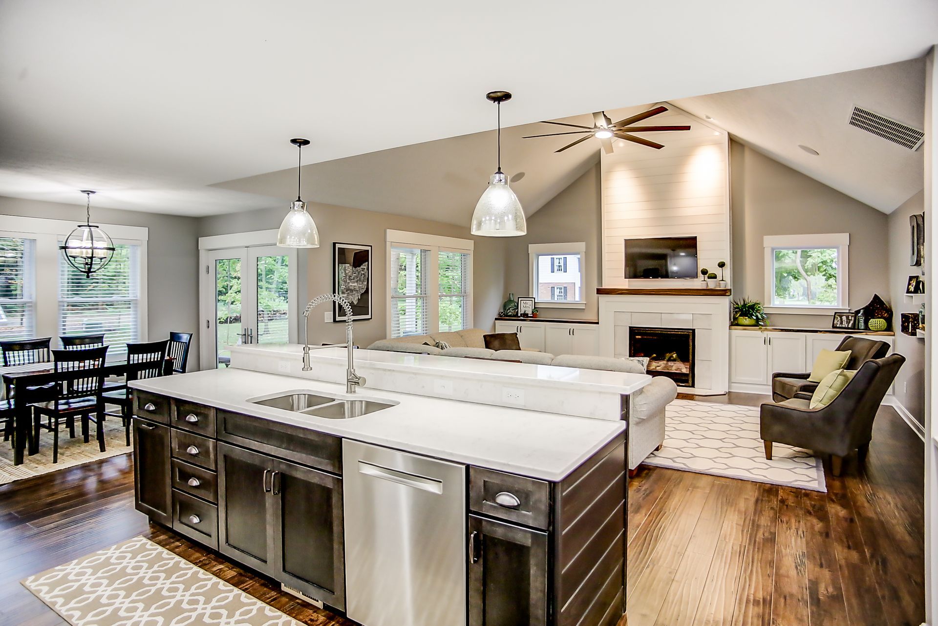 A kitchen with stainless steel appliances and a large island in the middle of the room.
