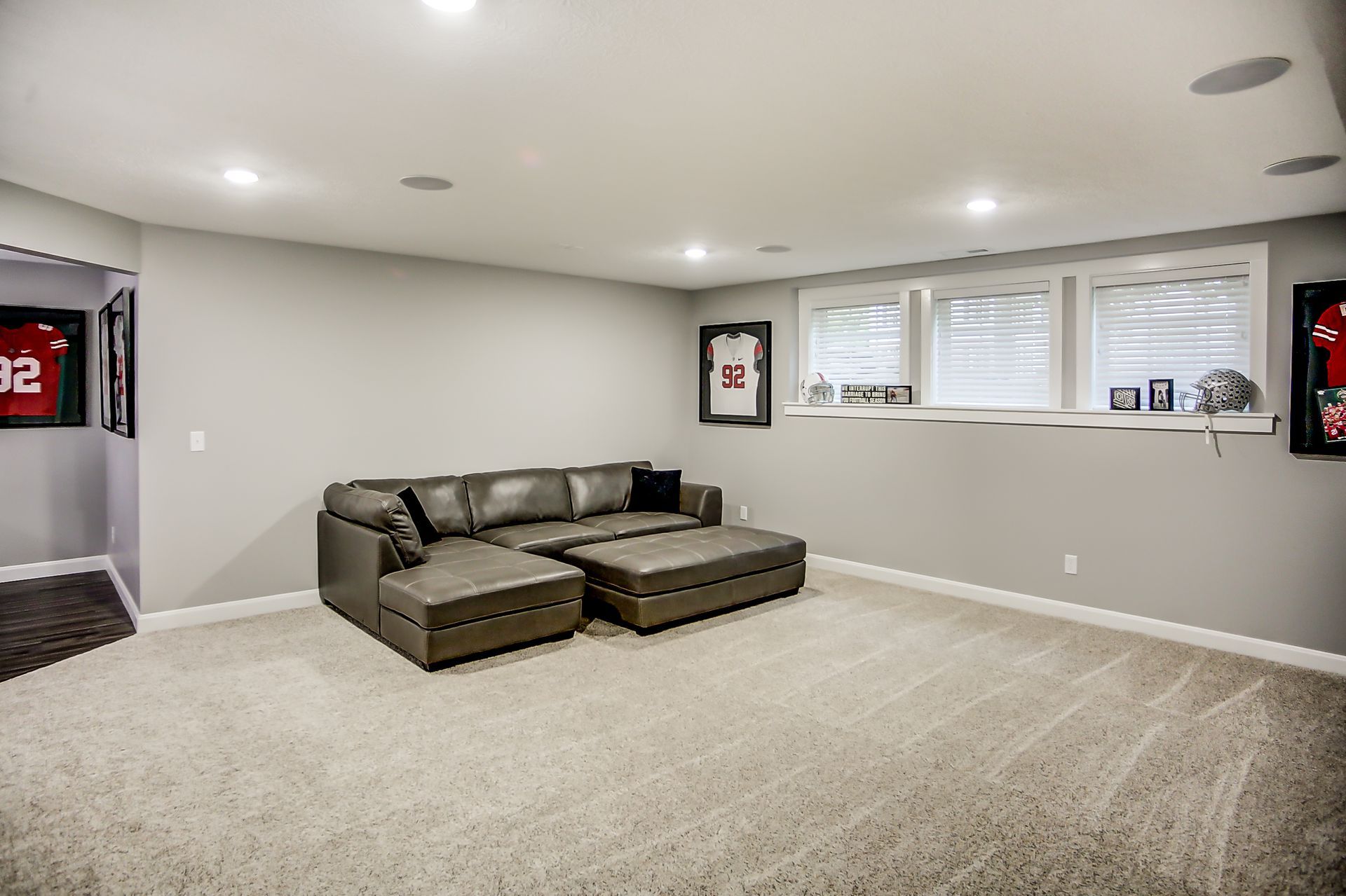 There is a couch in the middle of the room in the basement.