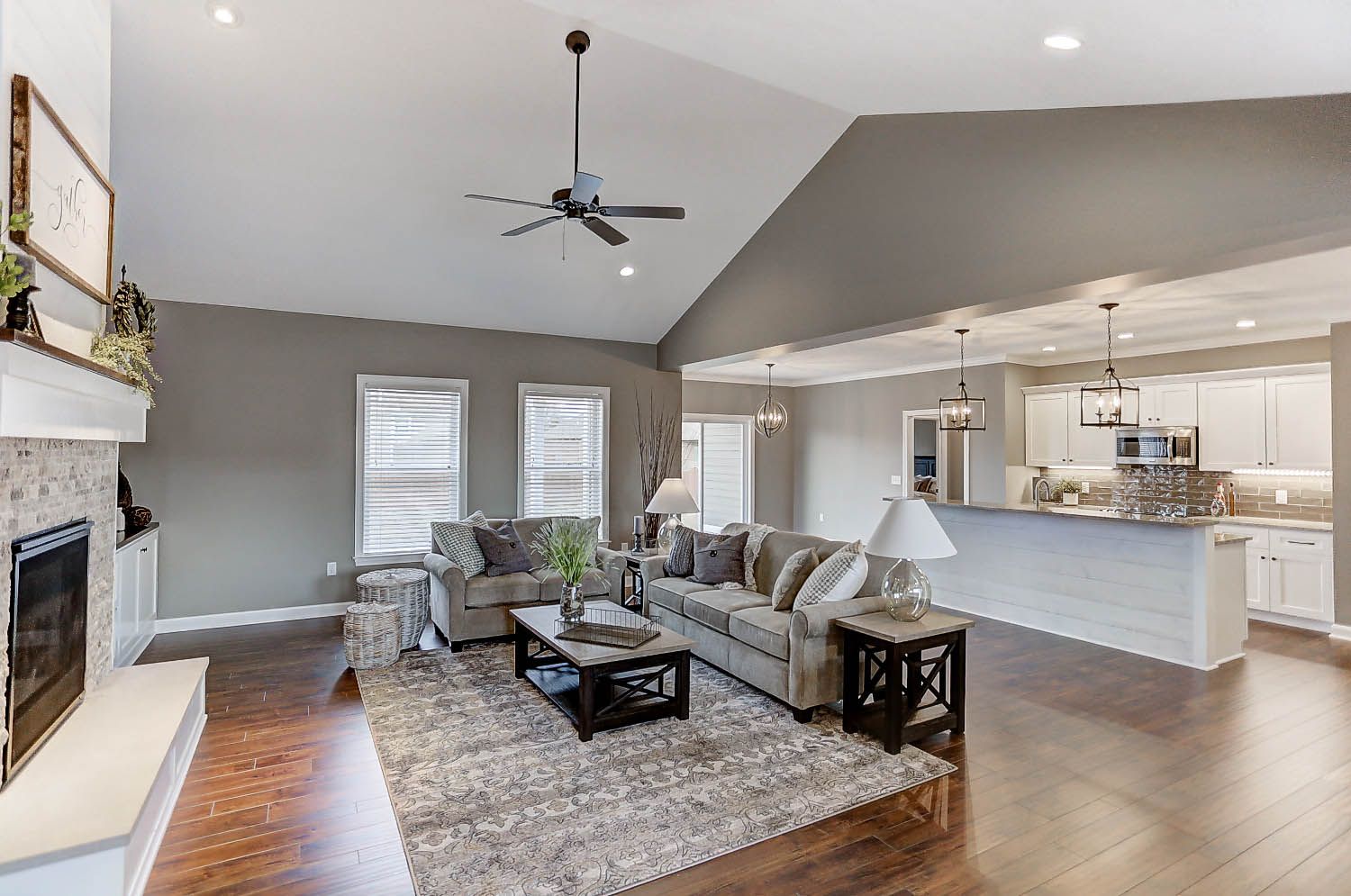 A living room filled with furniture and a ceiling fan.