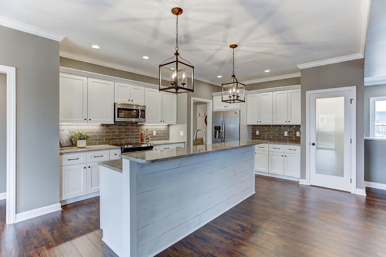 There is a large island in the middle of the kitchen.