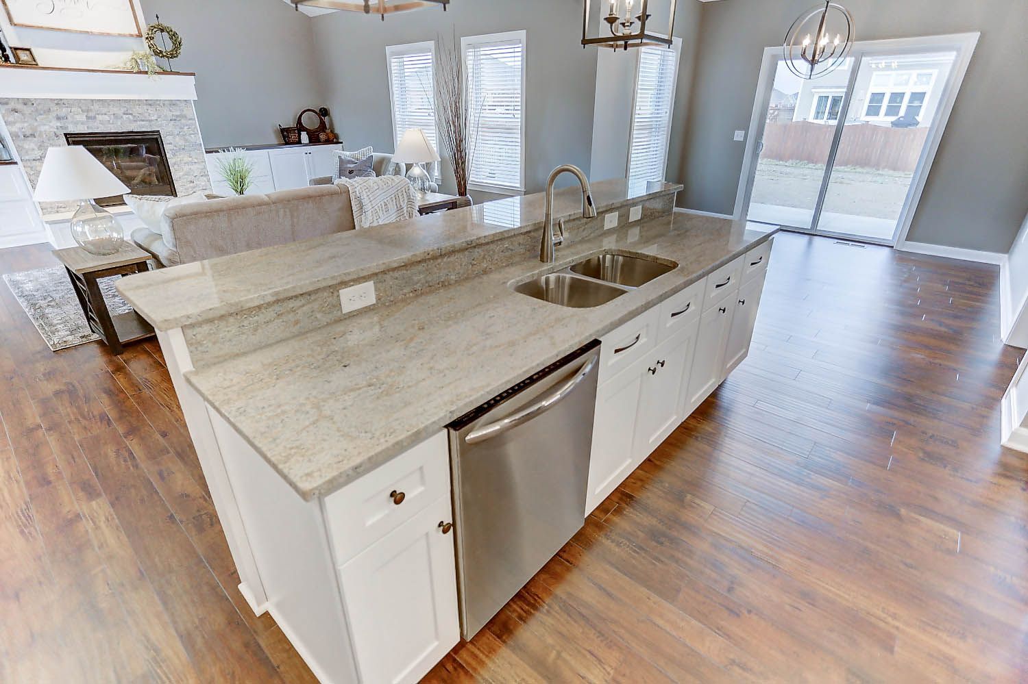 A kitchen with a sink and a dishwasher in a house.