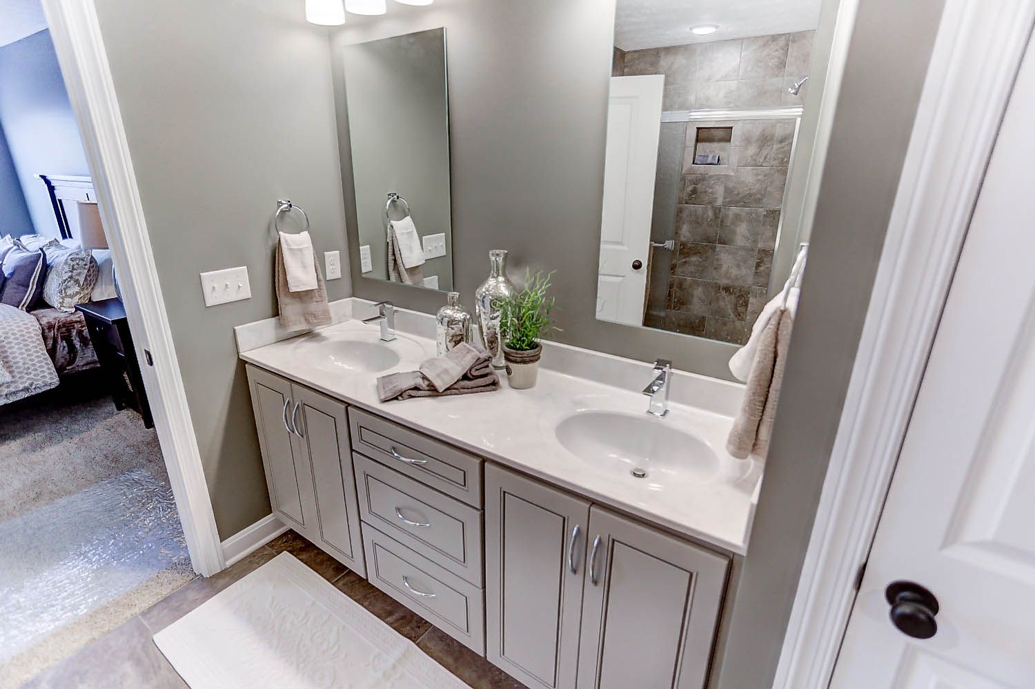 A bathroom with two sinks and two mirrors.