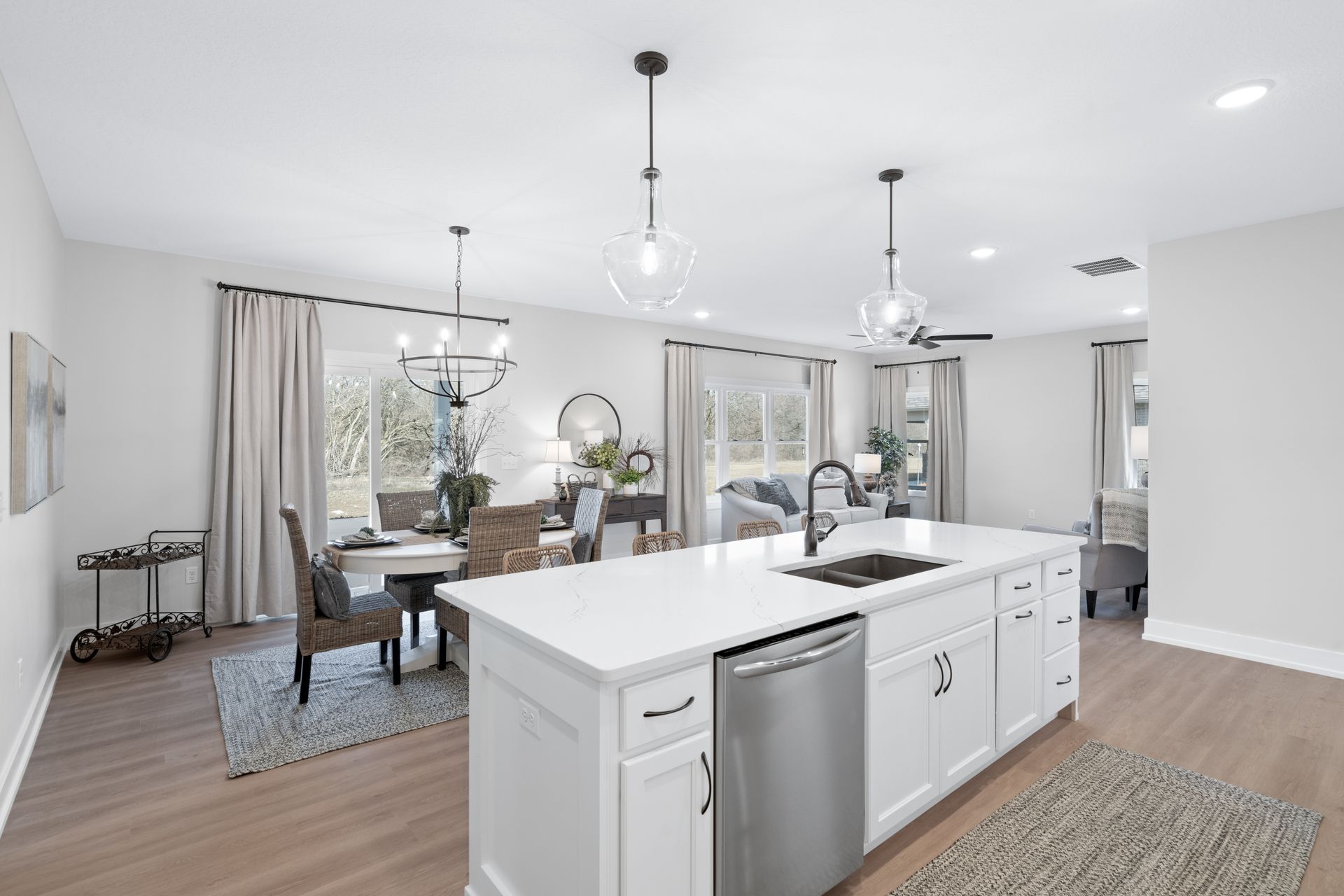 A kitchen with a large island and a stainless steel dishwasher.