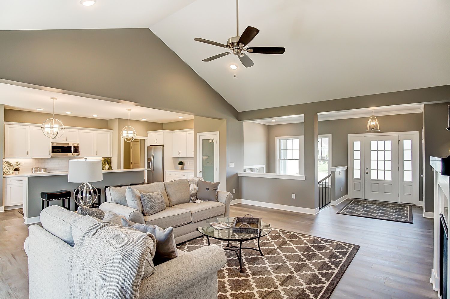 A living room filled with furniture and a ceiling fan.