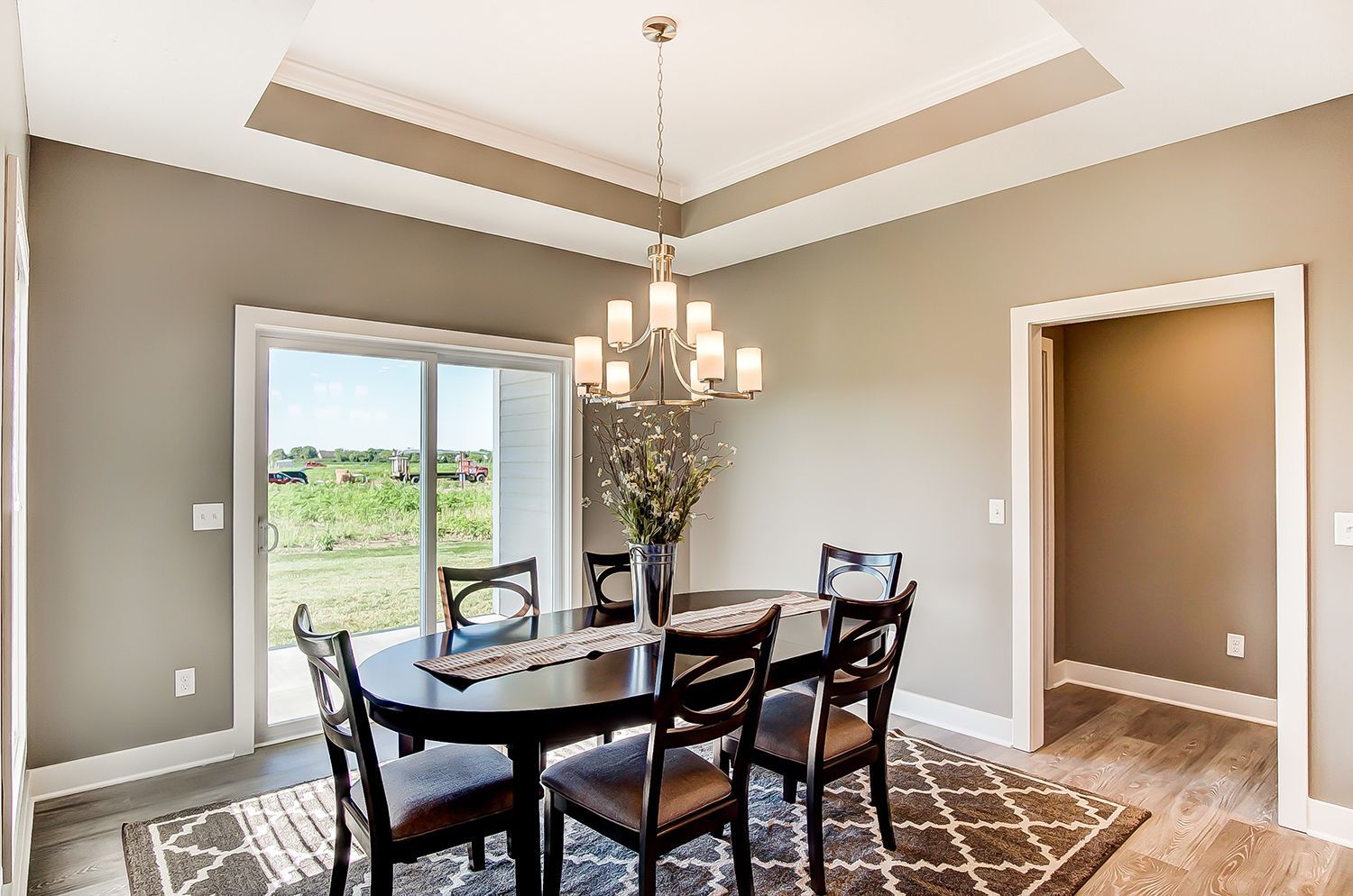 A dining room with a table and chairs and a chandelier.