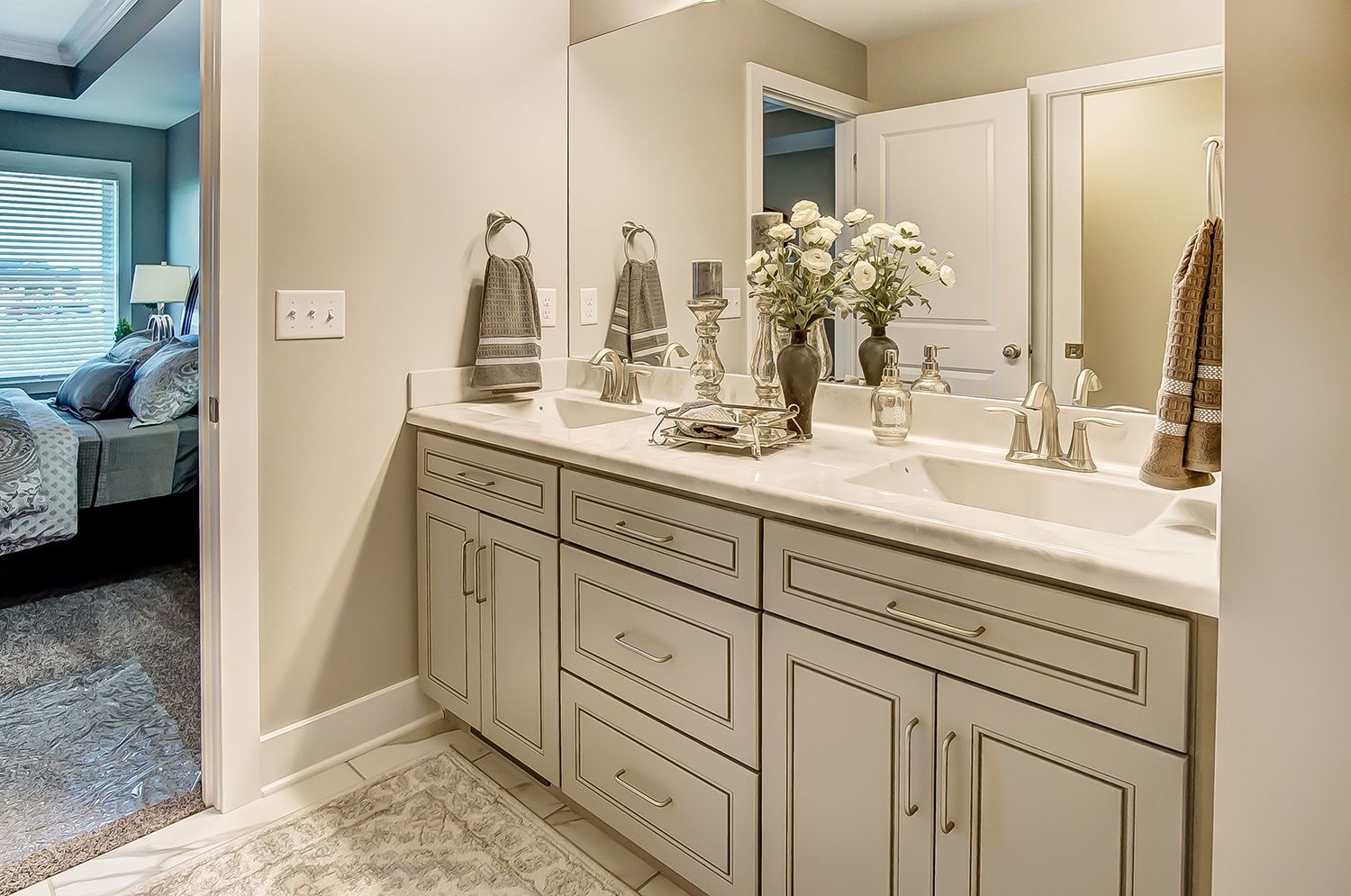 A bathroom with two sinks and a large mirror.