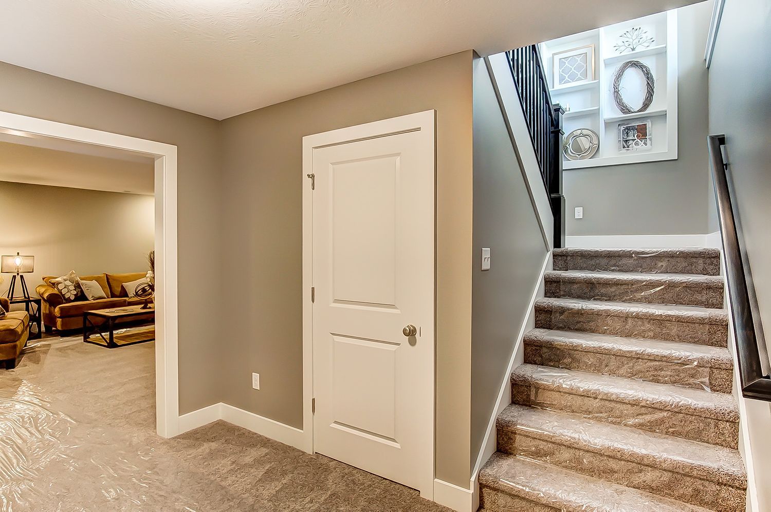 A hallway with stairs leading up to the second floor of a house.