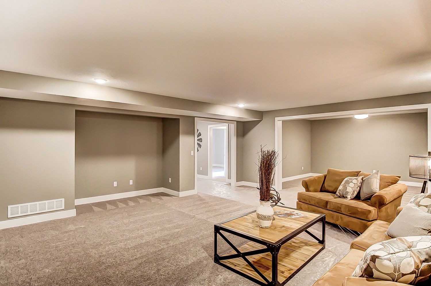 A living room in a basement with a couch and a coffee table.