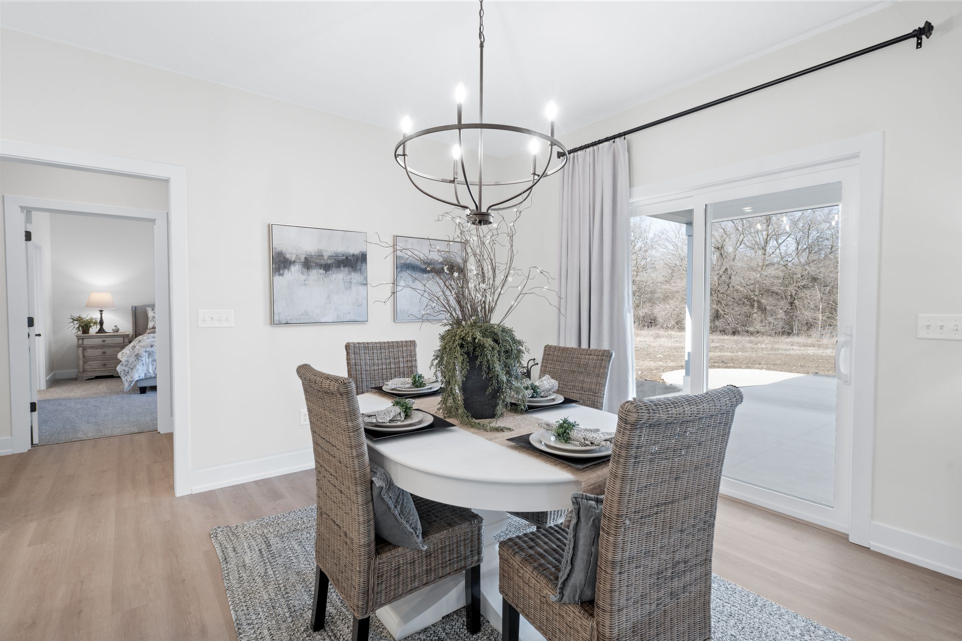 A dining room with a table and chairs and a chandelier.