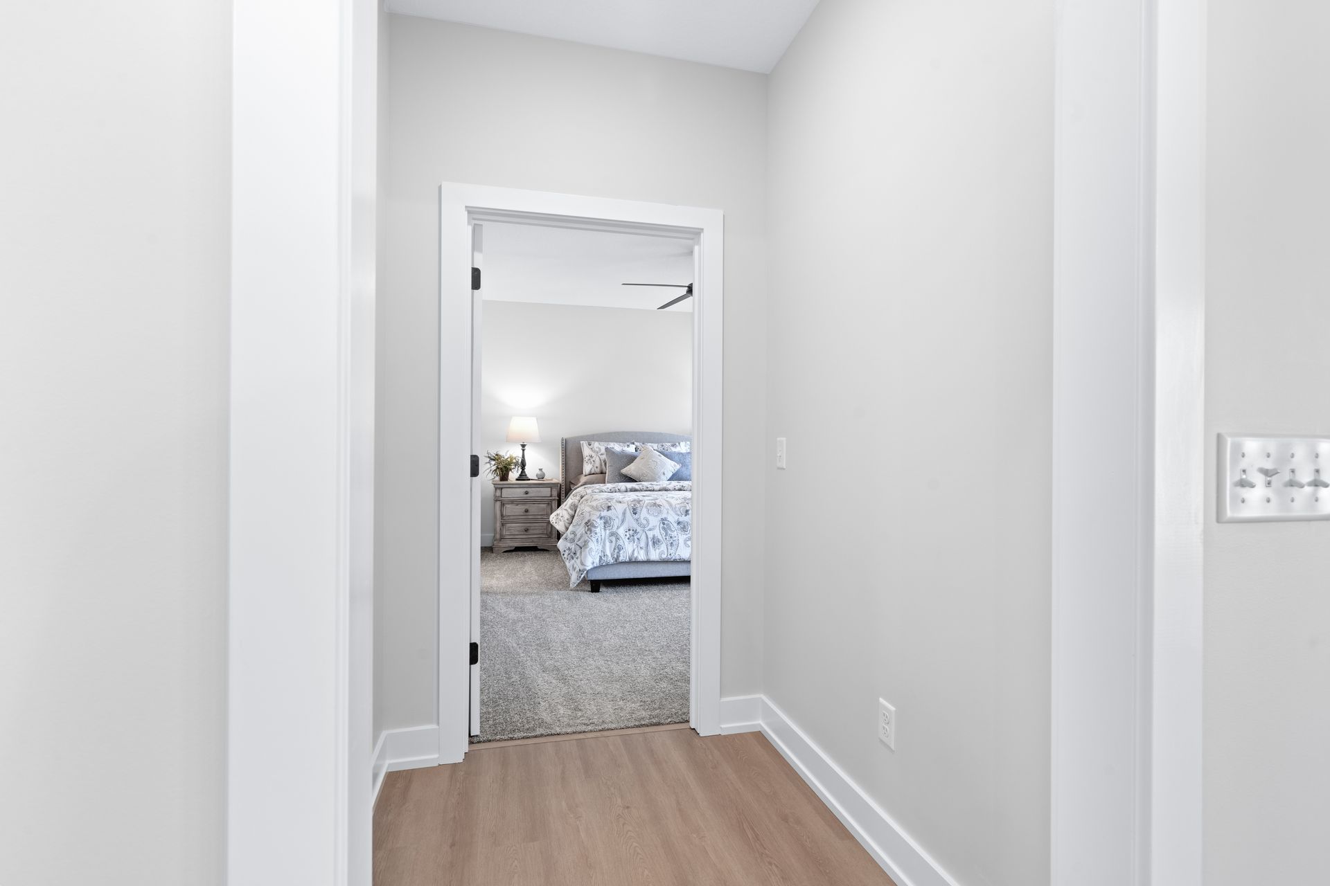 A hallway leading to a bedroom in a house.