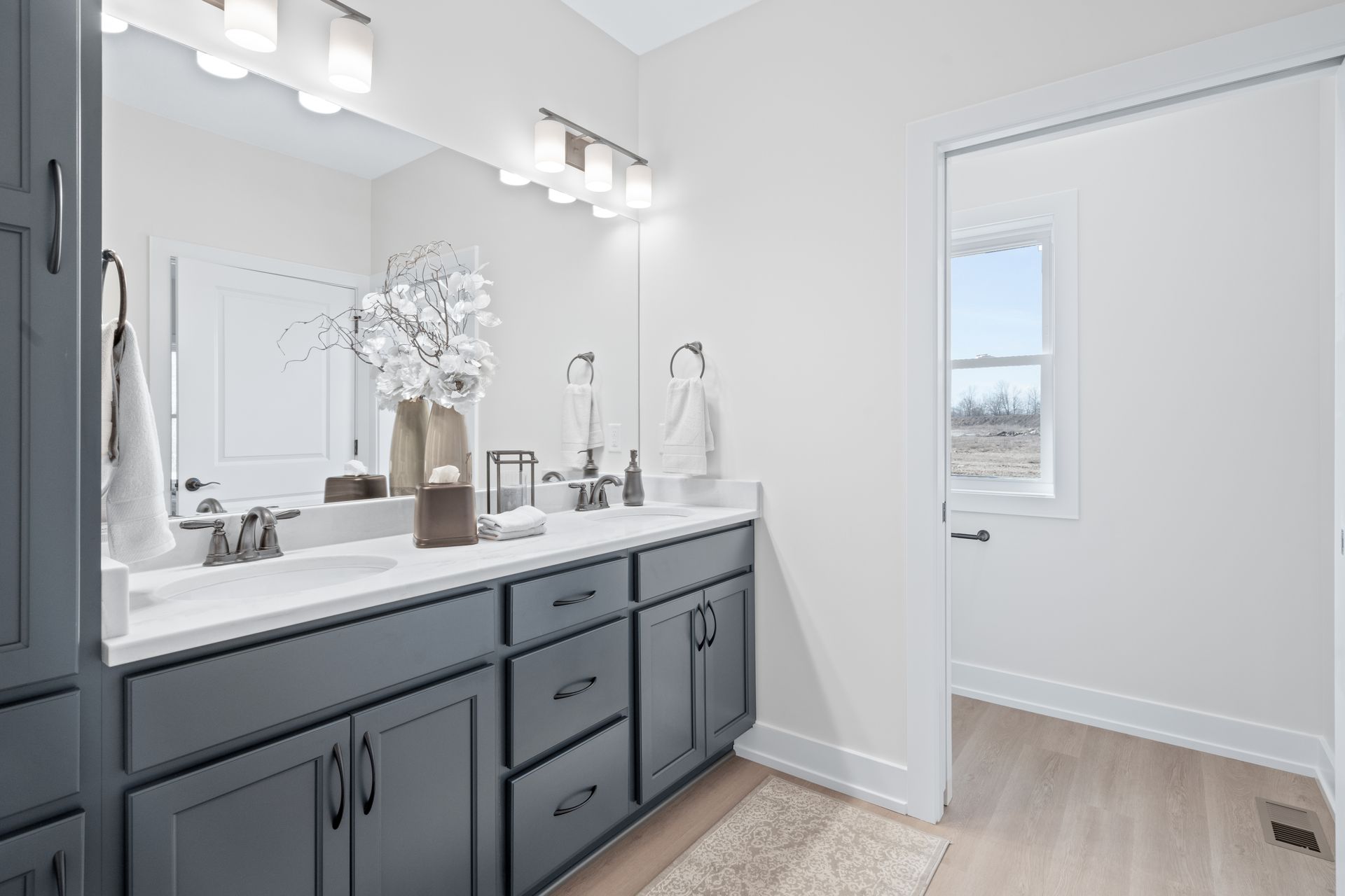 A bathroom with two sinks and a large mirror.