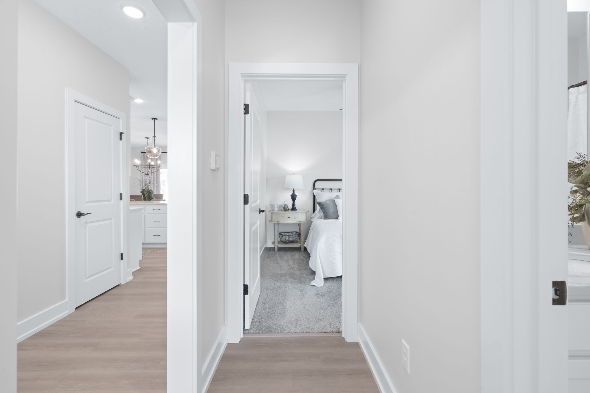 A hallway leading to a bedroom in a house.