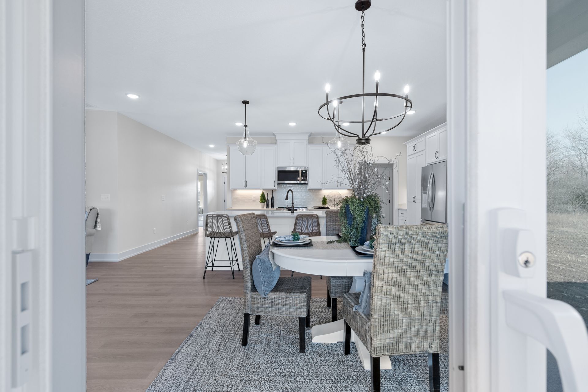 A dining room with a table and chairs and a chandelier.