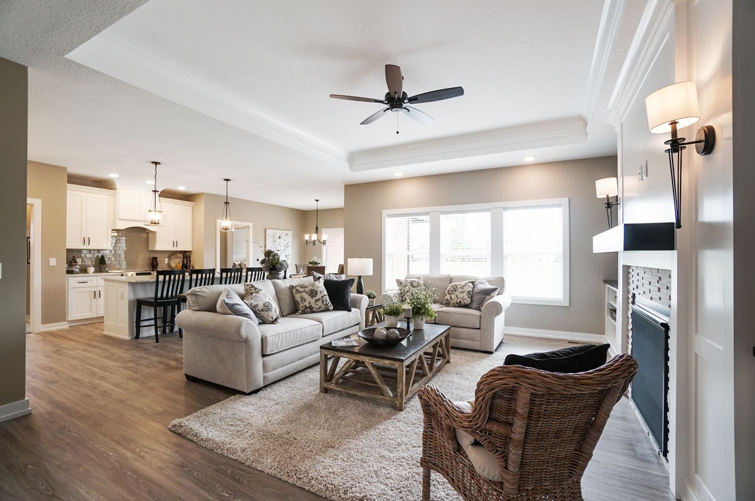 A living room with a couch , chair , coffee table and fireplace.