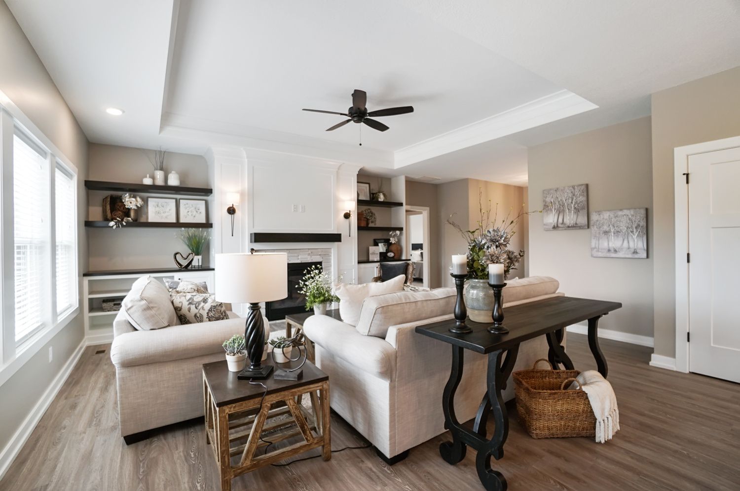 A living room filled with furniture and a ceiling fan.