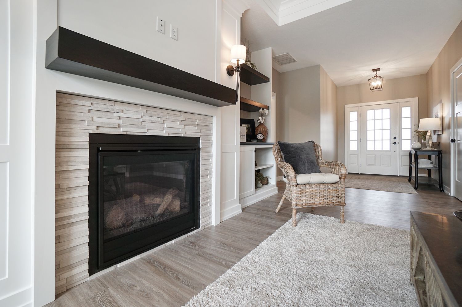 A living room with a fireplace , chair and rug.