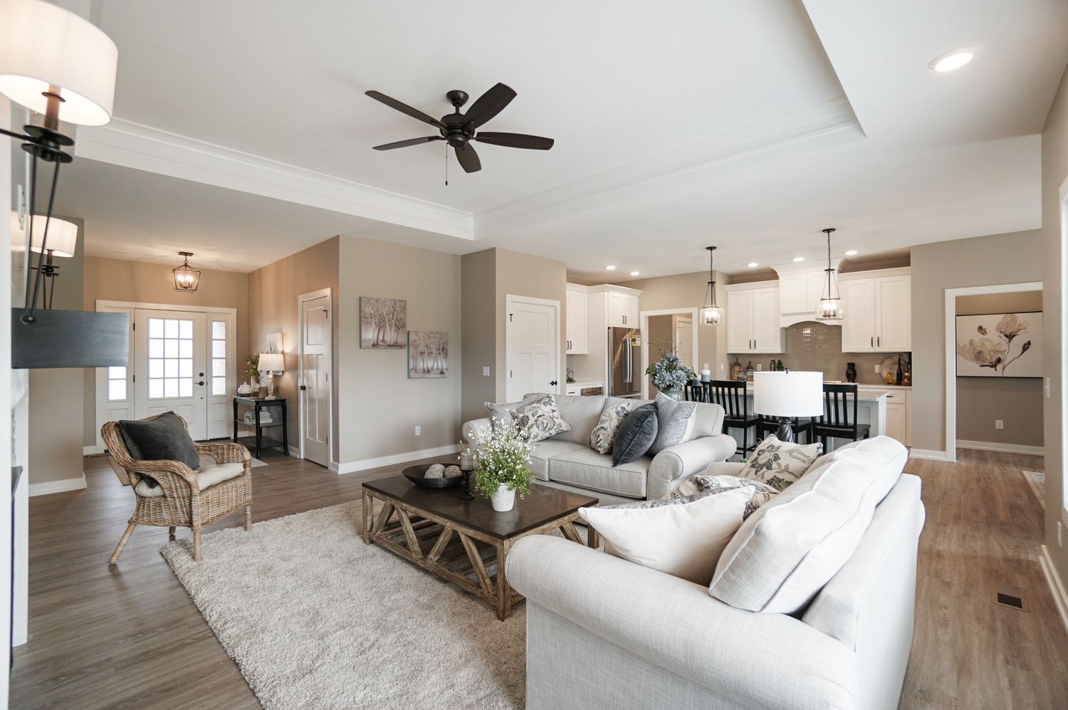 A living room filled with furniture and a ceiling fan.