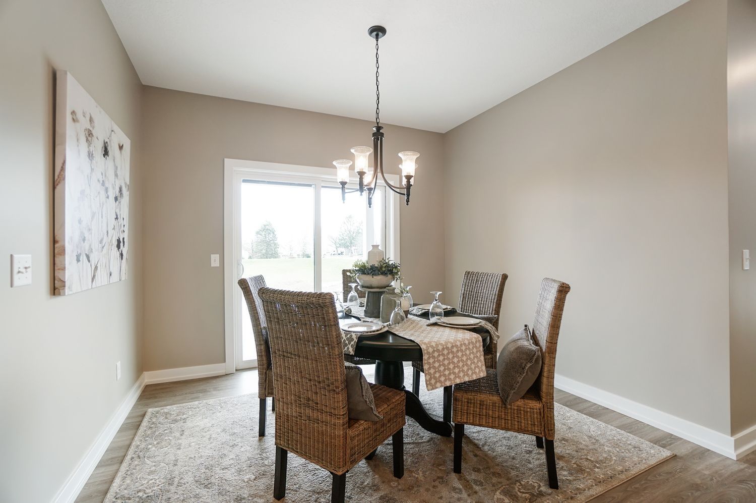 A dining room with a table and chairs and a chandelier.