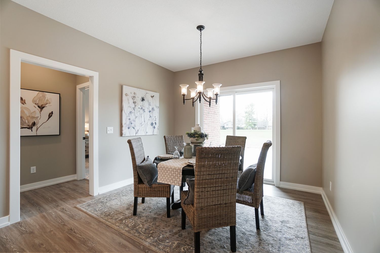 A dining room with a table and chairs and a chandelier.