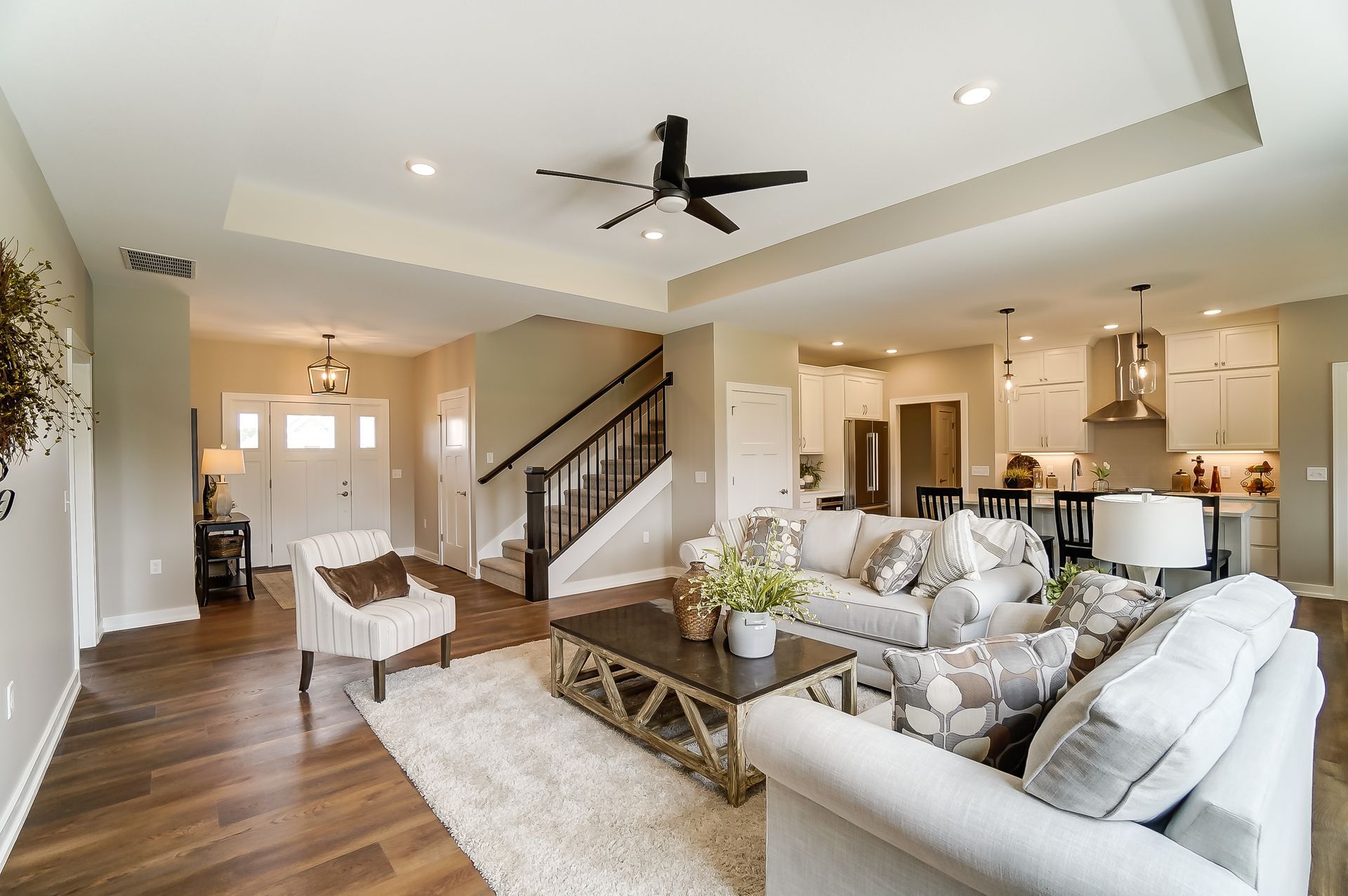 A living room filled with furniture and a ceiling fan.