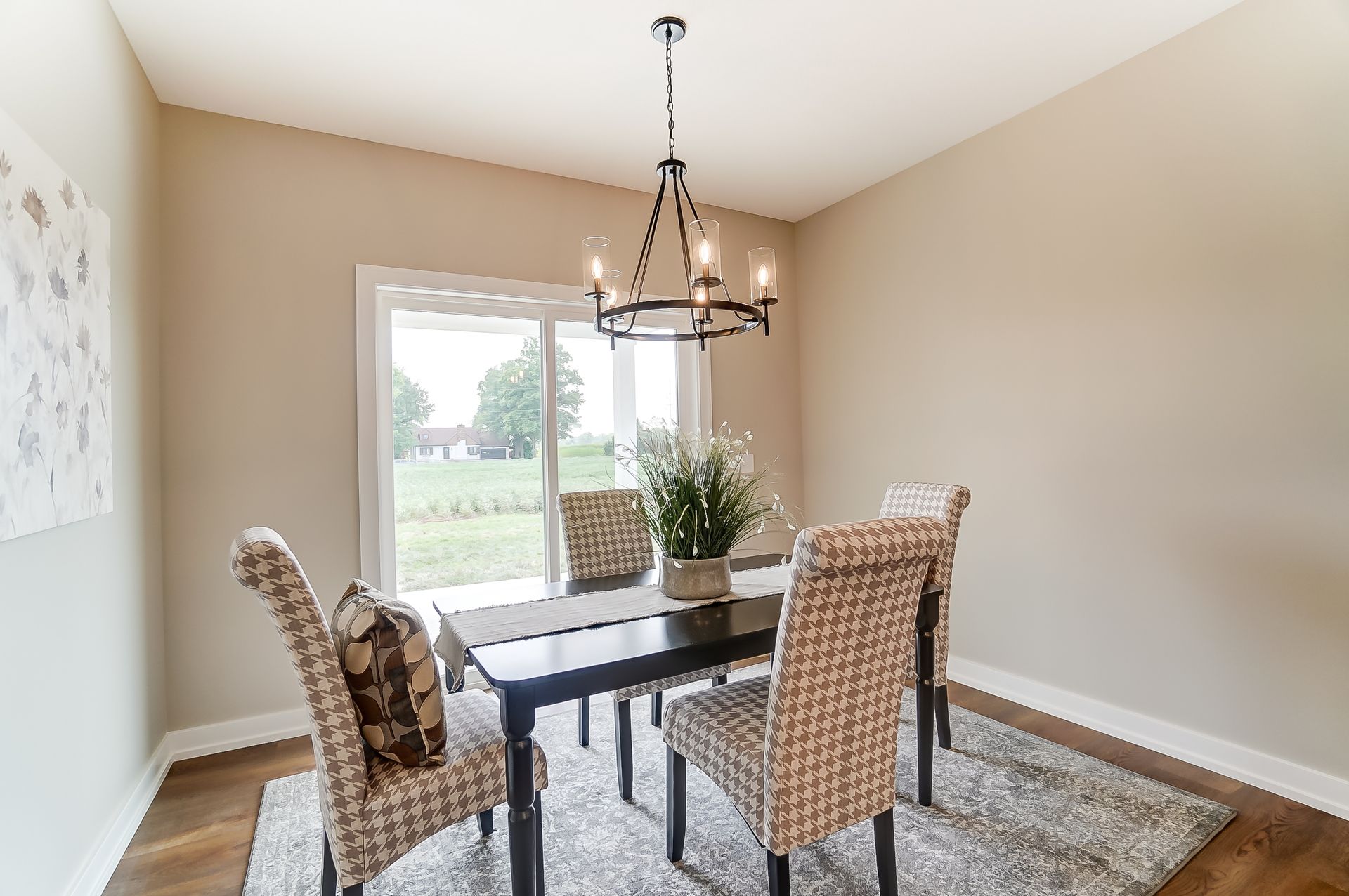 A dining room with a table and chairs and a chandelier.