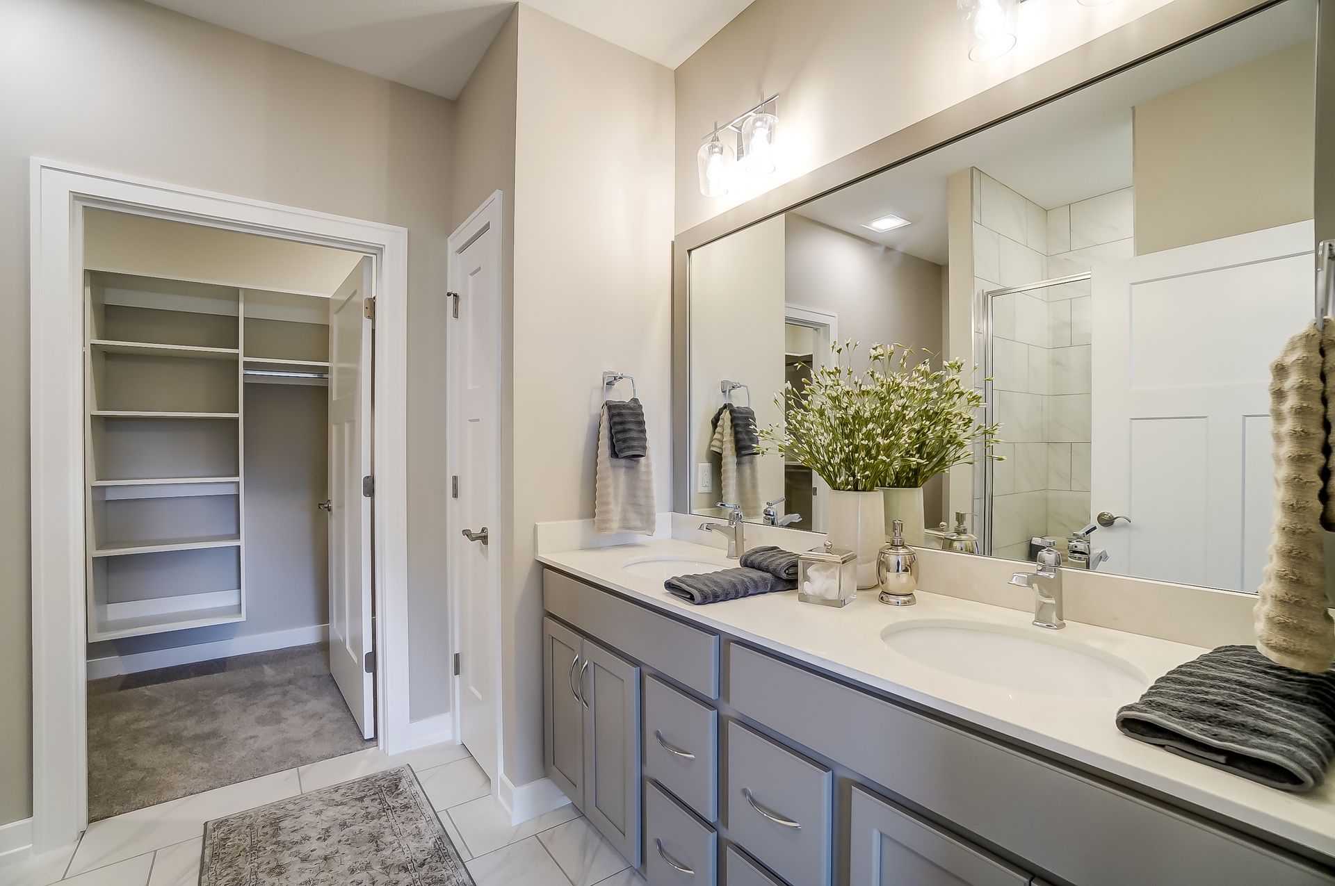 A bathroom with two sinks and a large mirror.