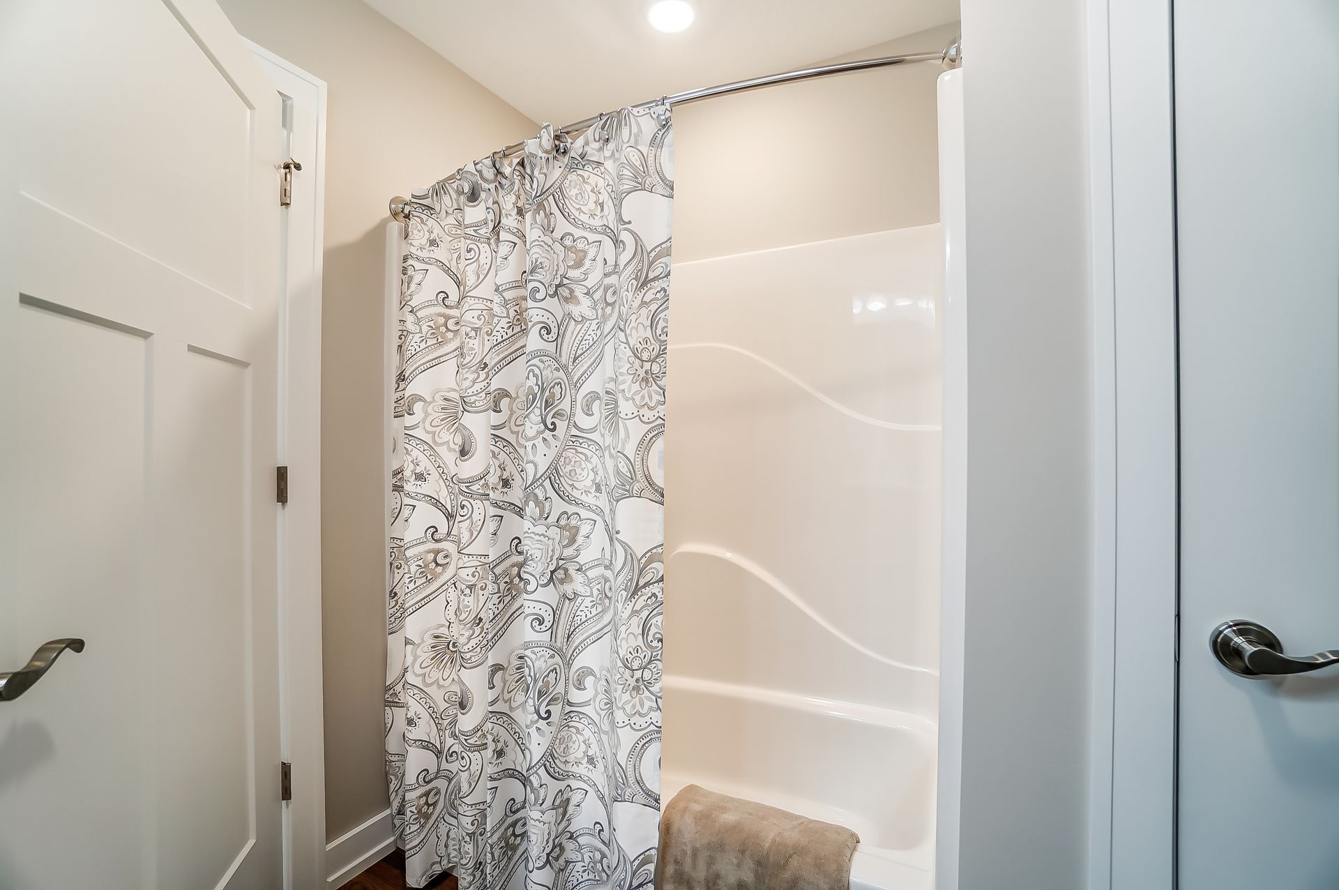 A bathroom with a shower curtain and a bathtub.