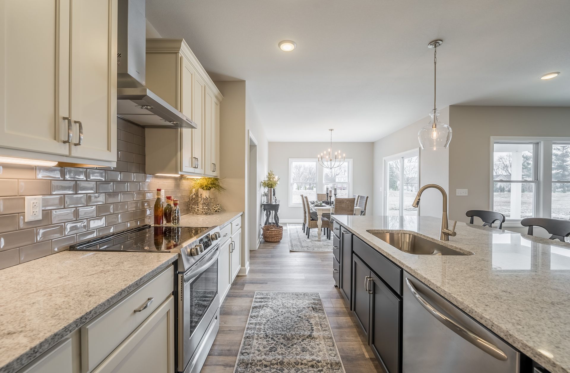 A kitchen with granite counter tops and stainless steel appliances.