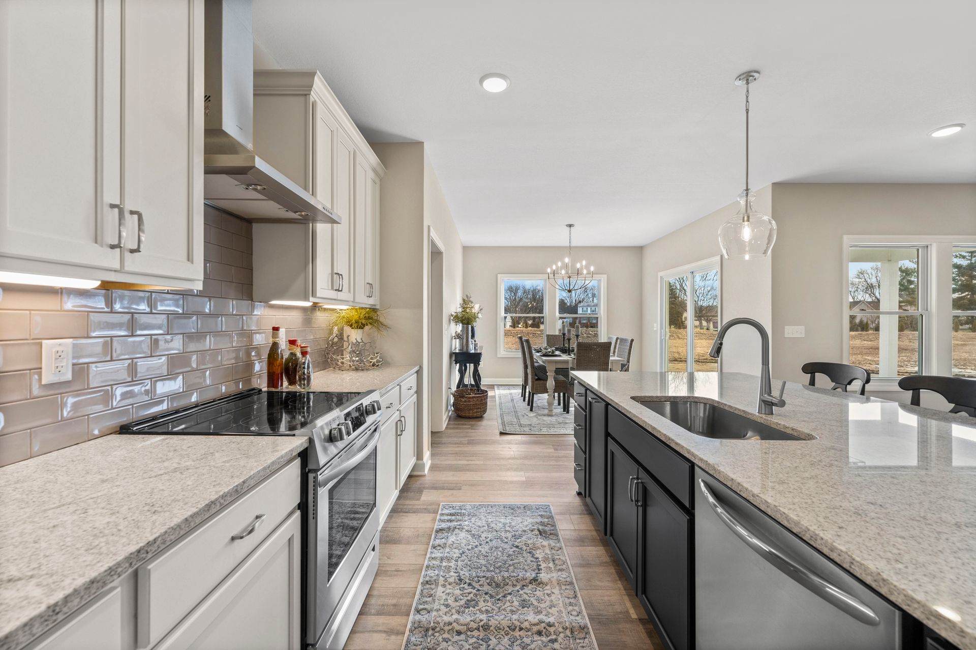 A kitchen with granite counter tops and stainless steel appliances.